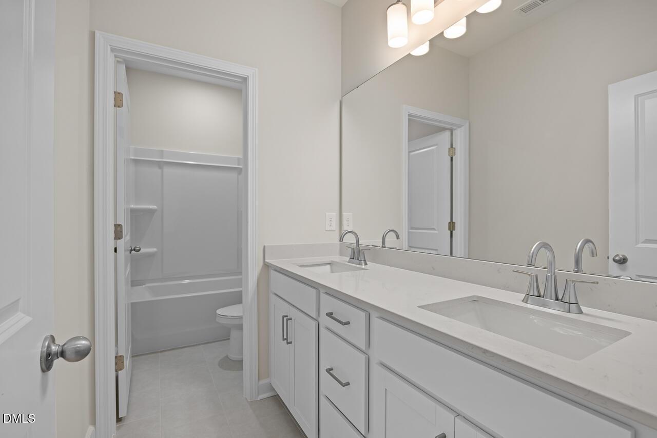 Modern double vanity bathroom with quartz countertops in The Hickory II B floor plan by Davidson Homes in Montrose, Aberdeen.