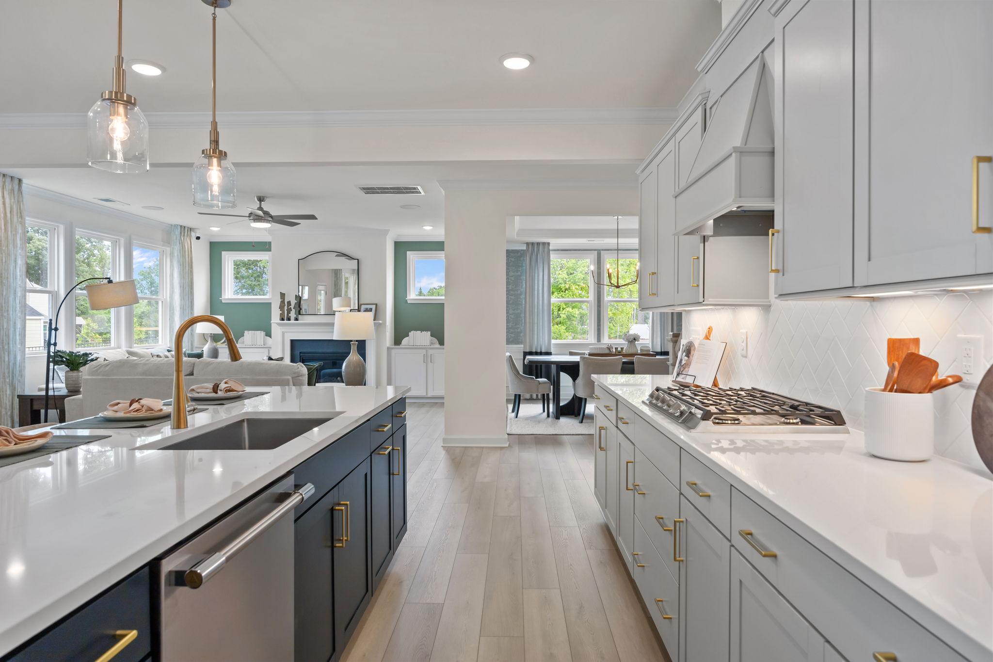 Modern gourmet kitchen in Springvale South by Davidson Homes with quartz countertops, custom cabinetry, and open floor plan.
