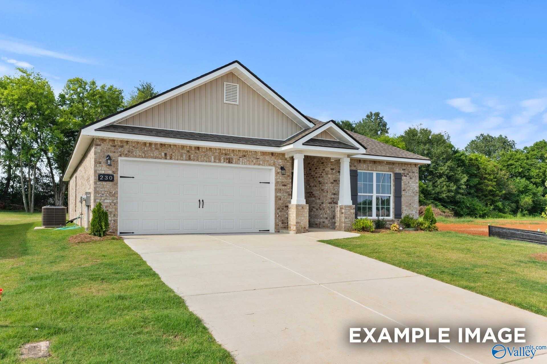 Modern brick single-story home with 2-car garage, covered porch, and lush landscaping in The Highlands, Arab, Alabama