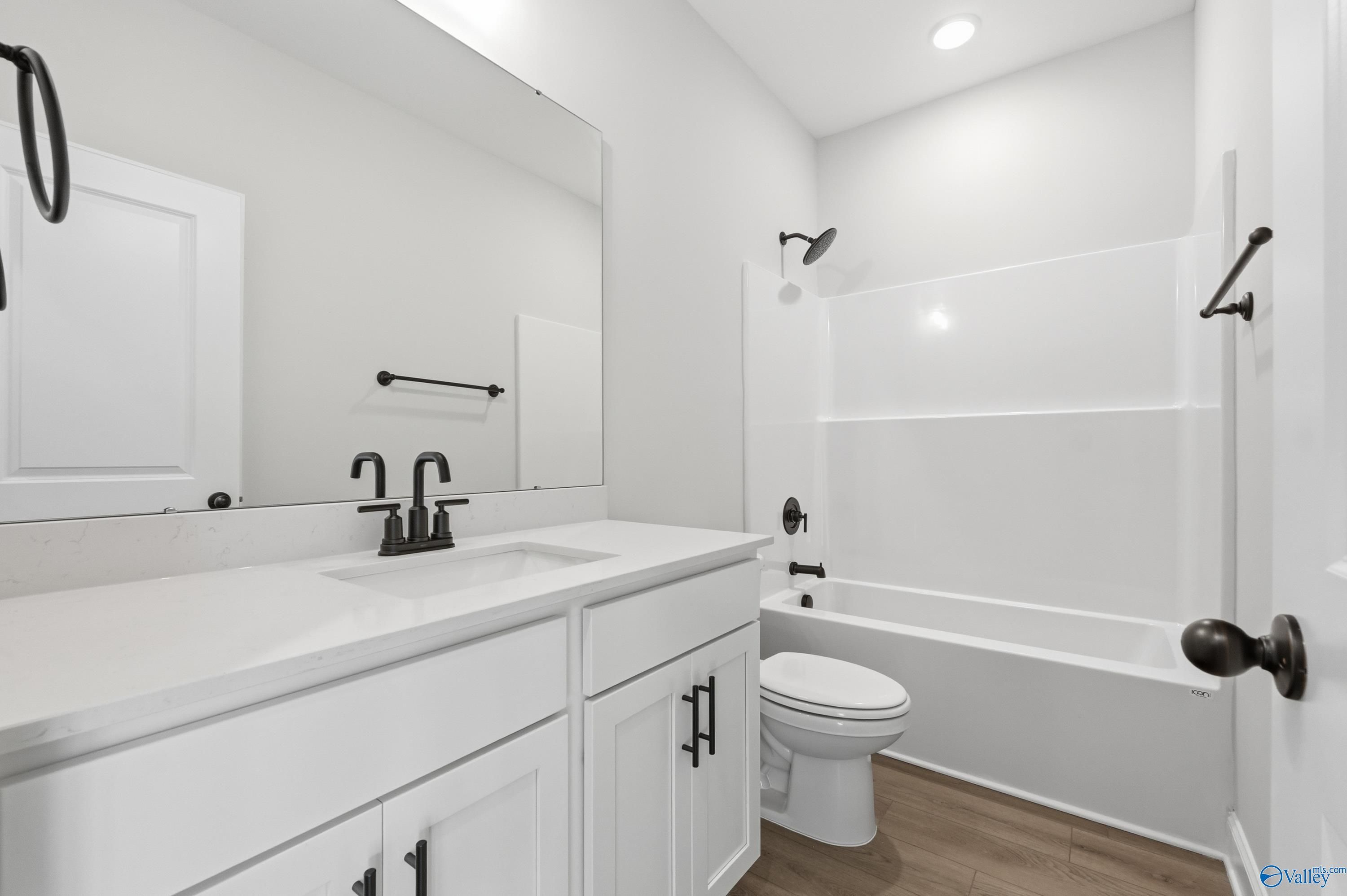 Modern bathroom with white double vanity, soaking tub, and walk-in shower in Davidson Homes The Daphne D, Arab, AL