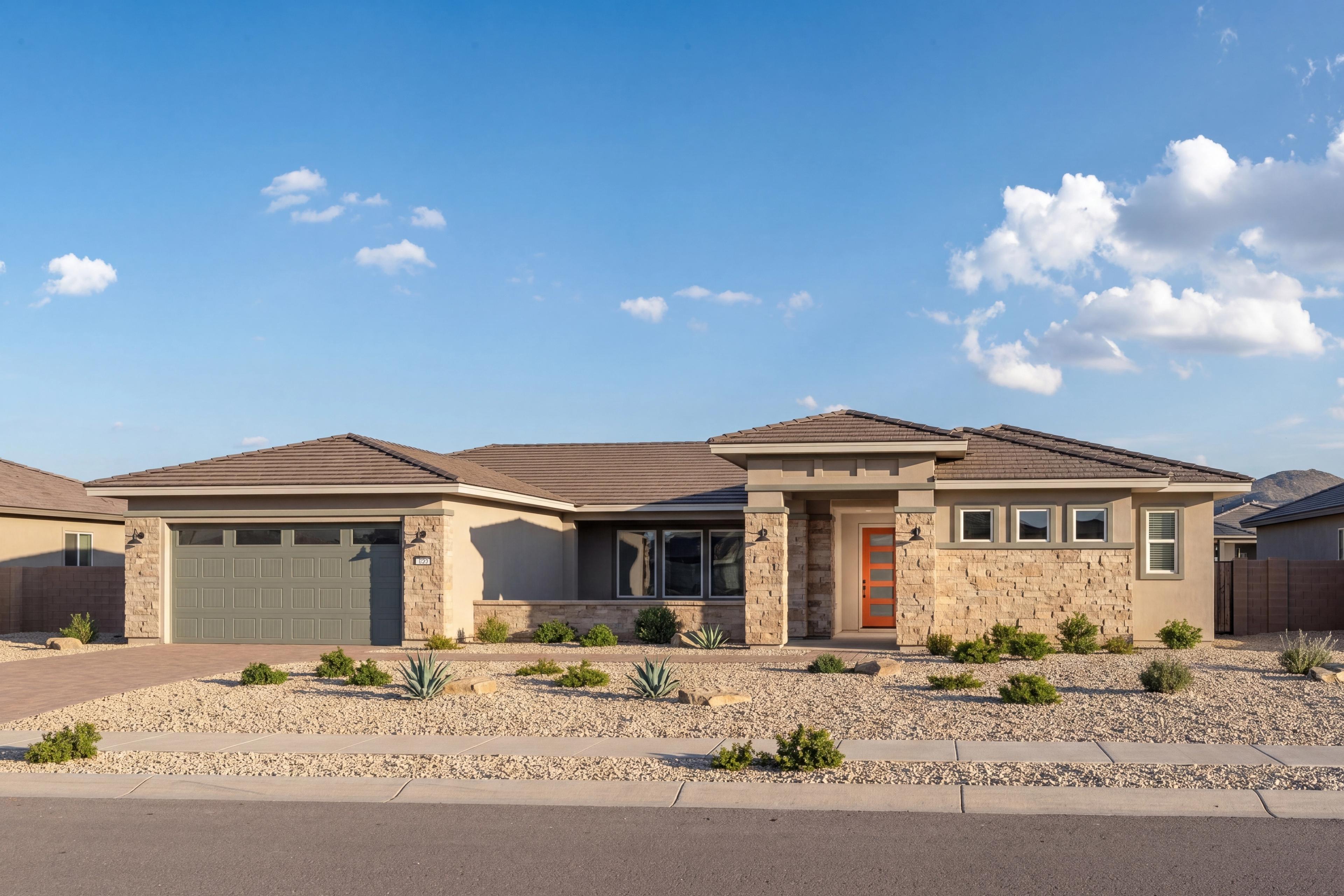 Contemporary single-story exterior of The Sundance in Prescott, featuring stone accents, desert landscaping, and garage.