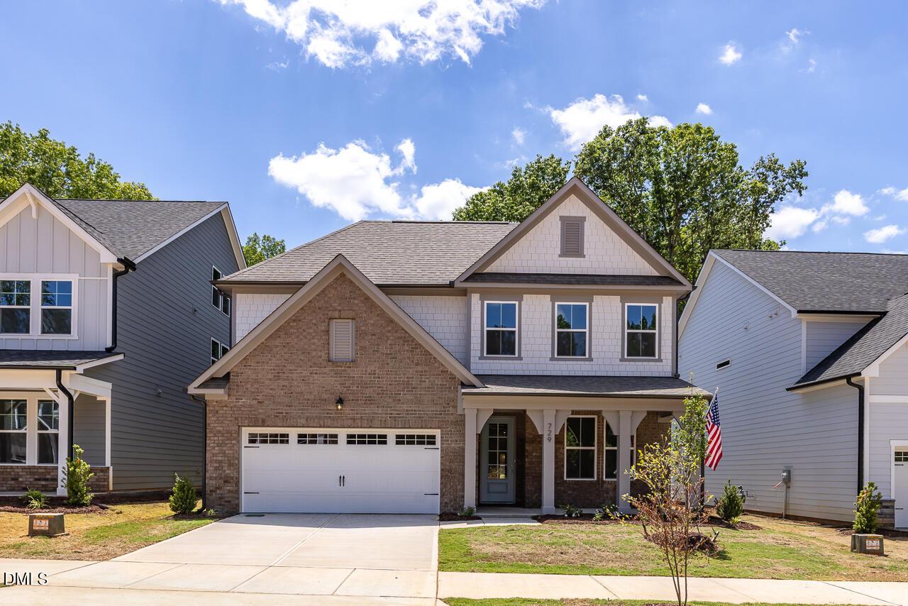 Two-story brick and siding home with 2-car garage, The Ashport G floor plan by Davidson Homes in Wake Forest, NC.