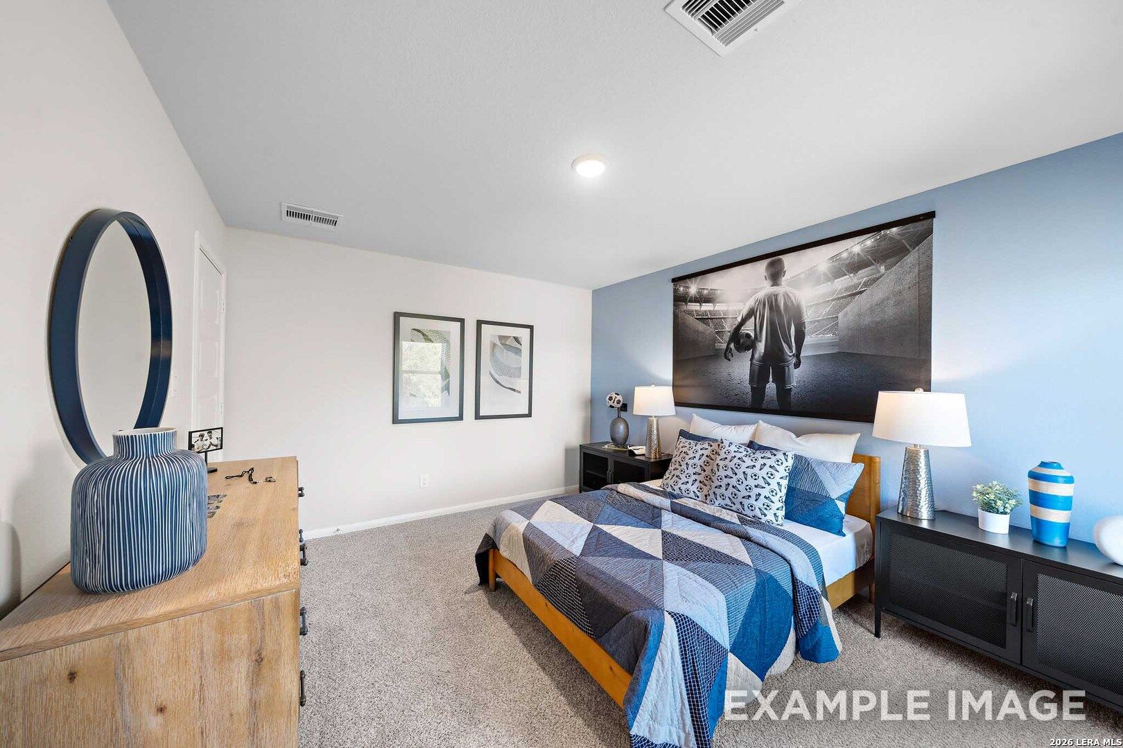Spacious blue-themed bedroom in Davidson Homes San Marcos F floor plan at Rayburn Valley, San Antonio, Texas.