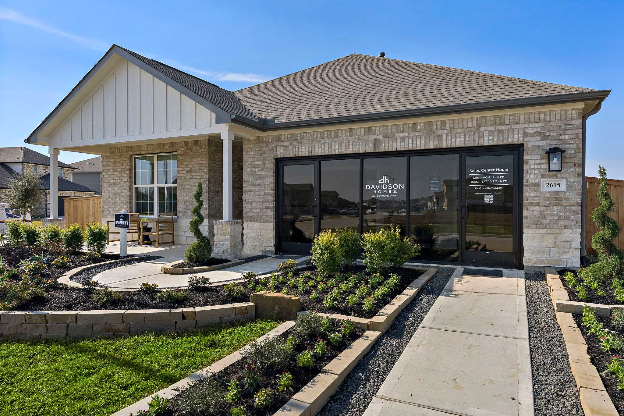 Davidson Homes model home exterior at Sundance Cove in Crosby Texas with brick facade large windows and landscaped pathway