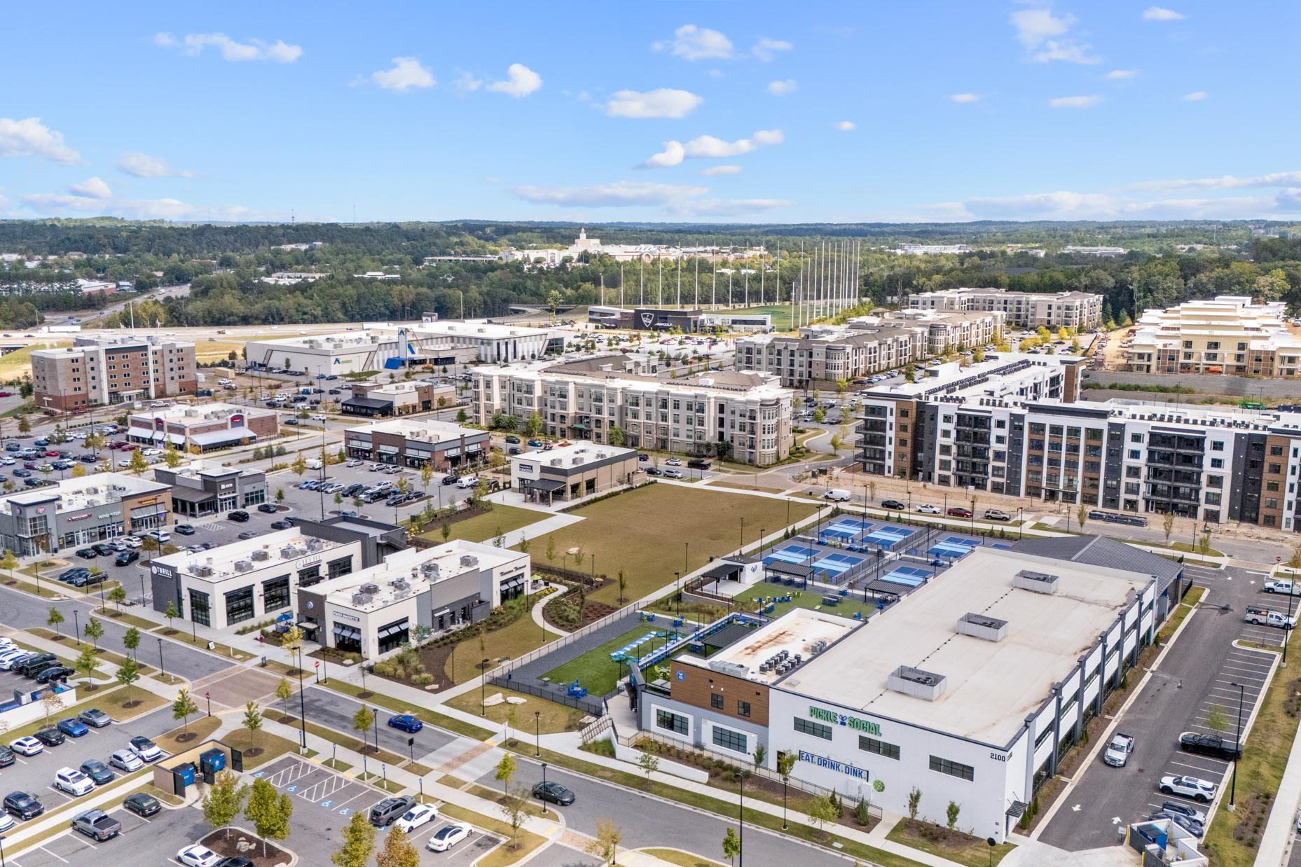 Aerial view of The Exchange at Buford near The Grove at East Thompson, featuring Pickle and Social and nearby apartments.