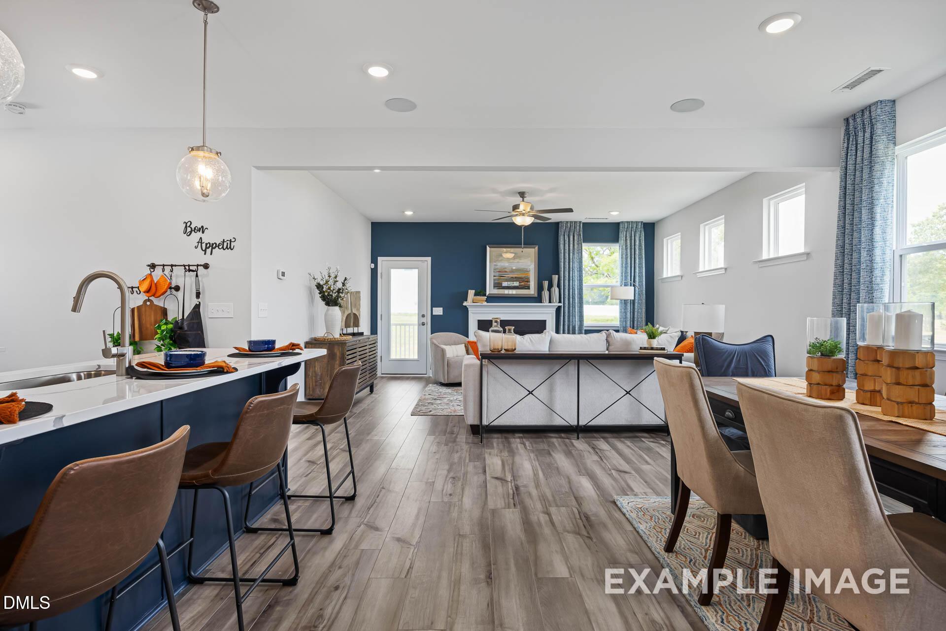 Open-concept living room and kitchen in The Adalynn A floor plan by Davidson Homes at Woodland Crossing, Zebulon, NC.