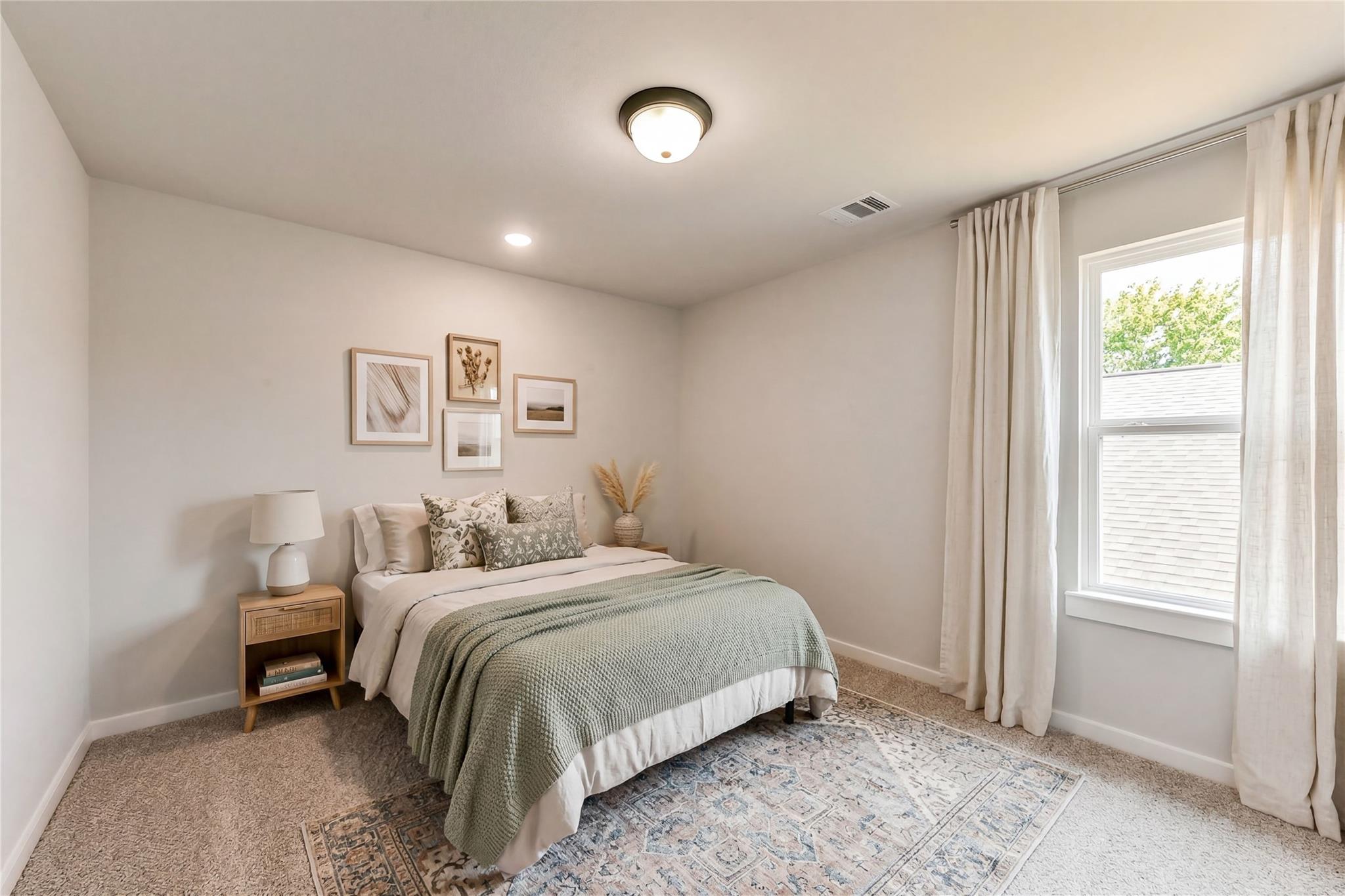 Cozy bedroom with queen bed, green throw, botanical art, and large window in Davidson Homes Sequoia C, Crosby, Texas