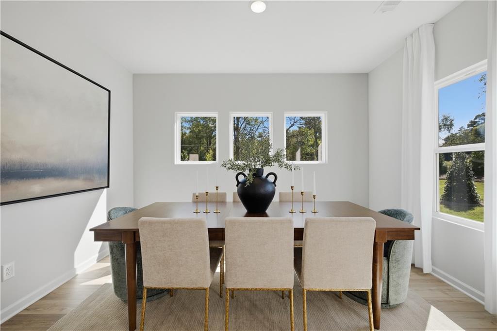 Bright dining room with wood table, upholstered chairs, and natural light in Davidson Homes Sinclair B, Cartersville, Georgia