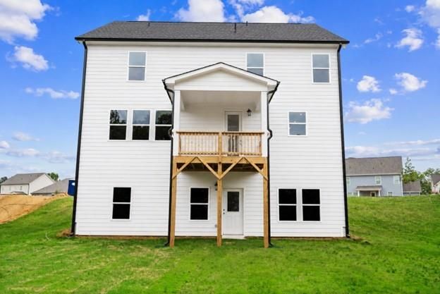Back exterior view of The Hickory A floor plan by Davidson Homes featuring a raised deck in Wehunt Meadows, Hoschton, GA.