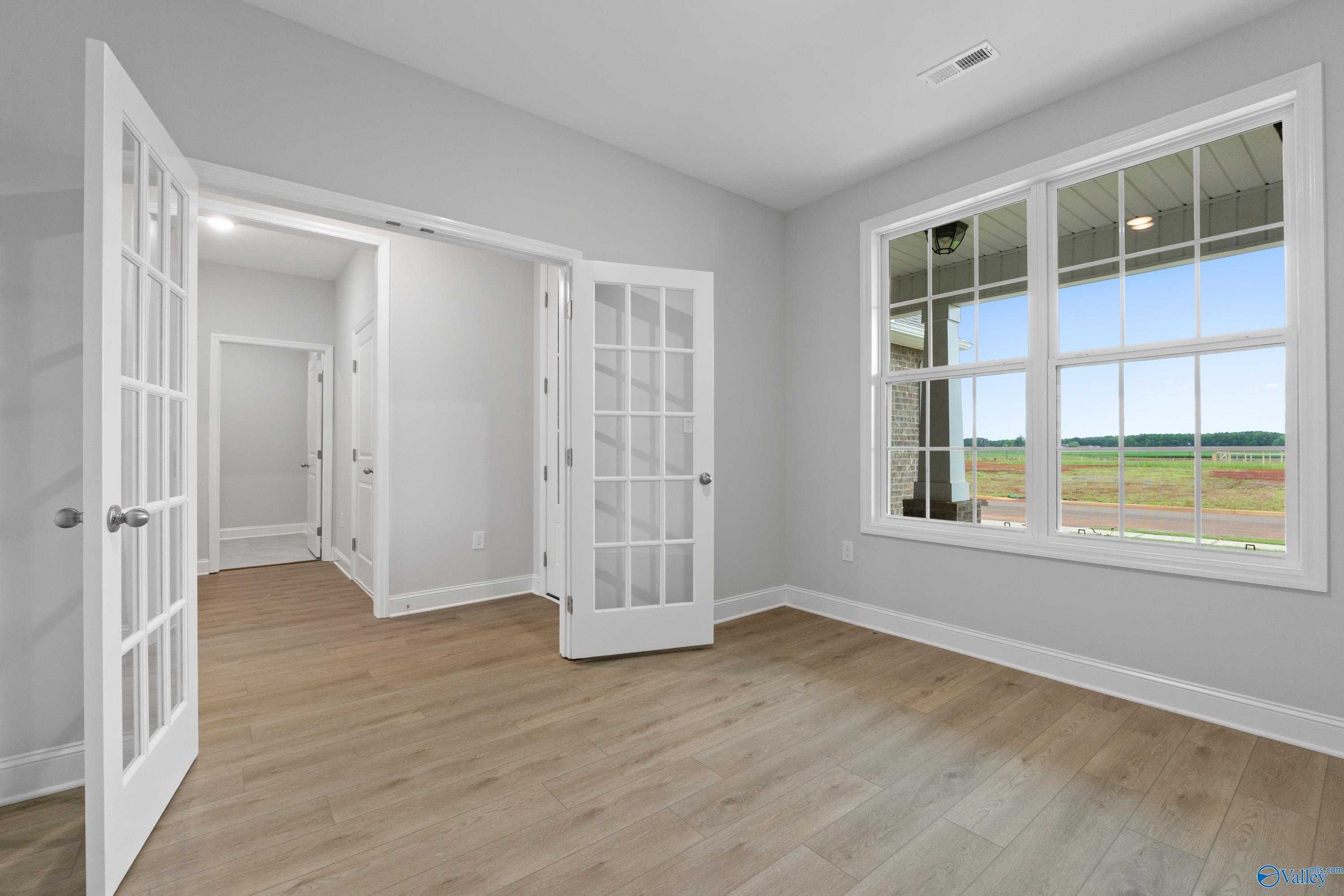 Bright bonus room with open French doors and large windows overlooking fields in Davidson Homes The Rockford B, Toney, Alabama