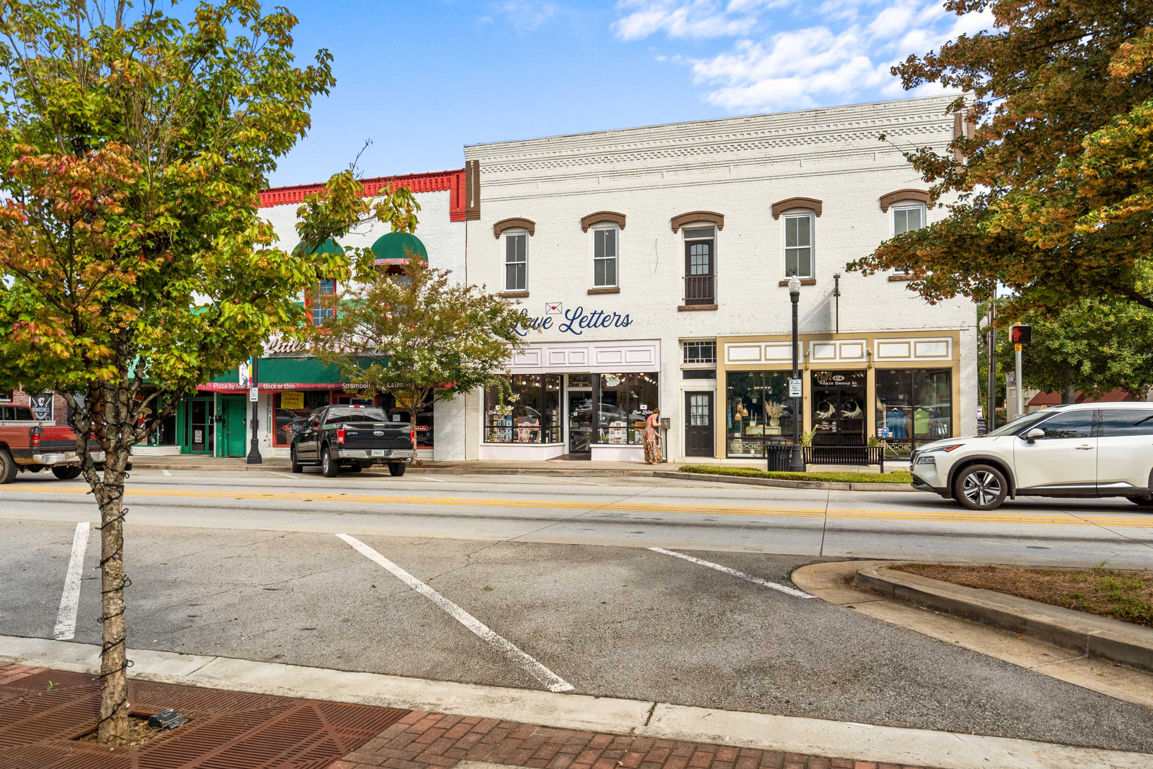 Charming downtown Winder Georgia street near Lake Shore community with historic shops, Letters storefront, and autumn trees