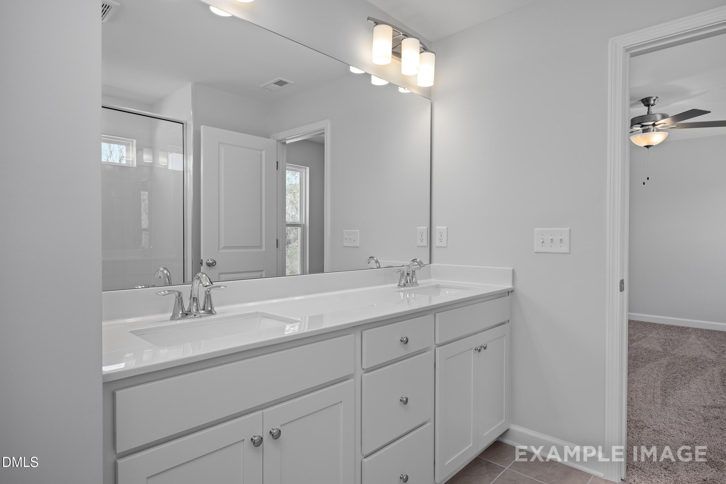 Modern dual-vanity bathroom in The Gavin A floor plan by Davidson Homes at Gregory Village in Lillington, North Carolina.