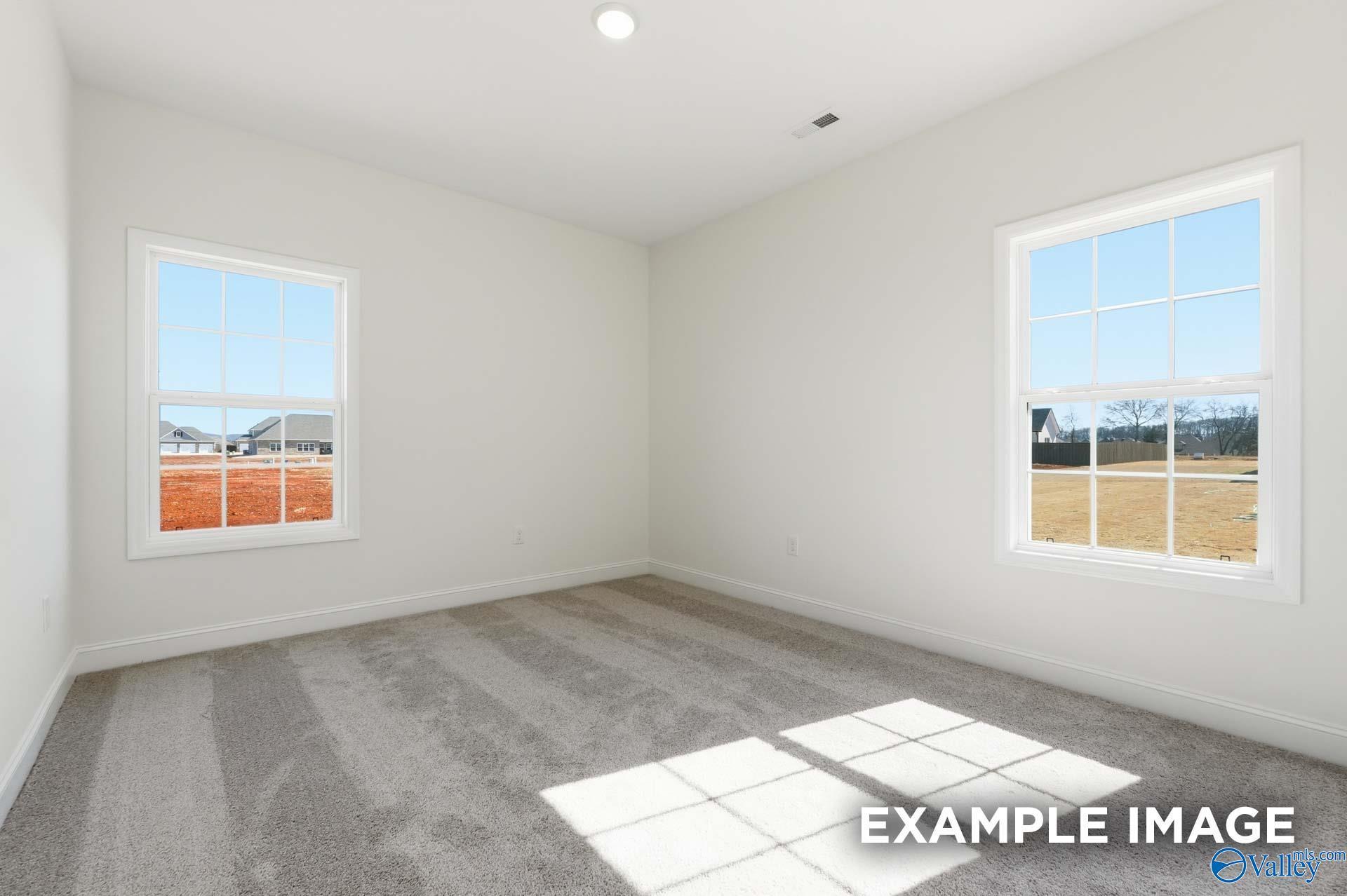 Bright, spacious bedroom with plush carpet and large windows in The Valencia floor plan, Briercreek, Meridianville, AL.