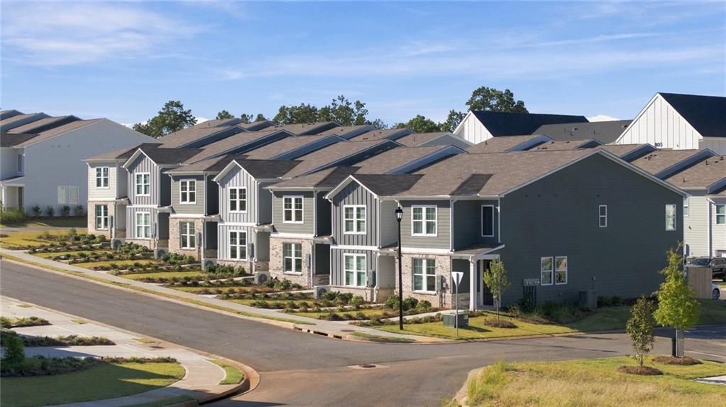 Row of new two-story homes with gray siding in Davidson Homes' Stegall Village community, Emerson, Georgia
