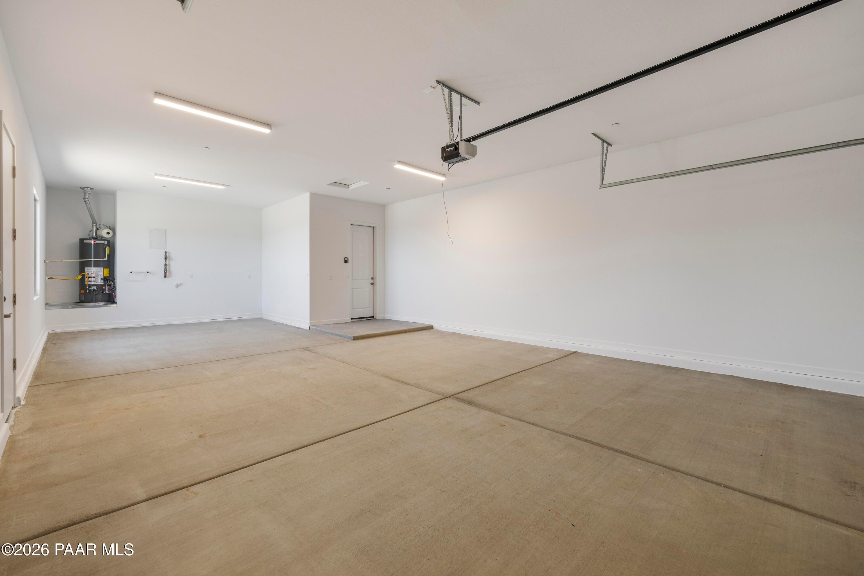 Spacious 3-car garage with polished concrete floor and utility panel in Davidson Homes The Soleil E, Hidden Hills, Prescott, Arizona
