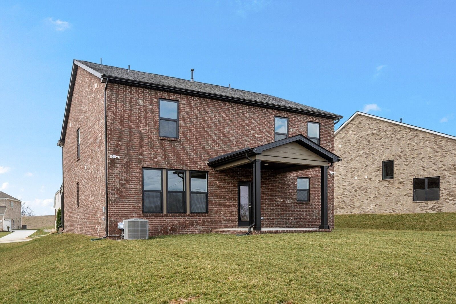 Two-story brick home with covered back patio in Benders Cove, Mt. Juliet, Tennessee, featuring The Henry C floor plan.