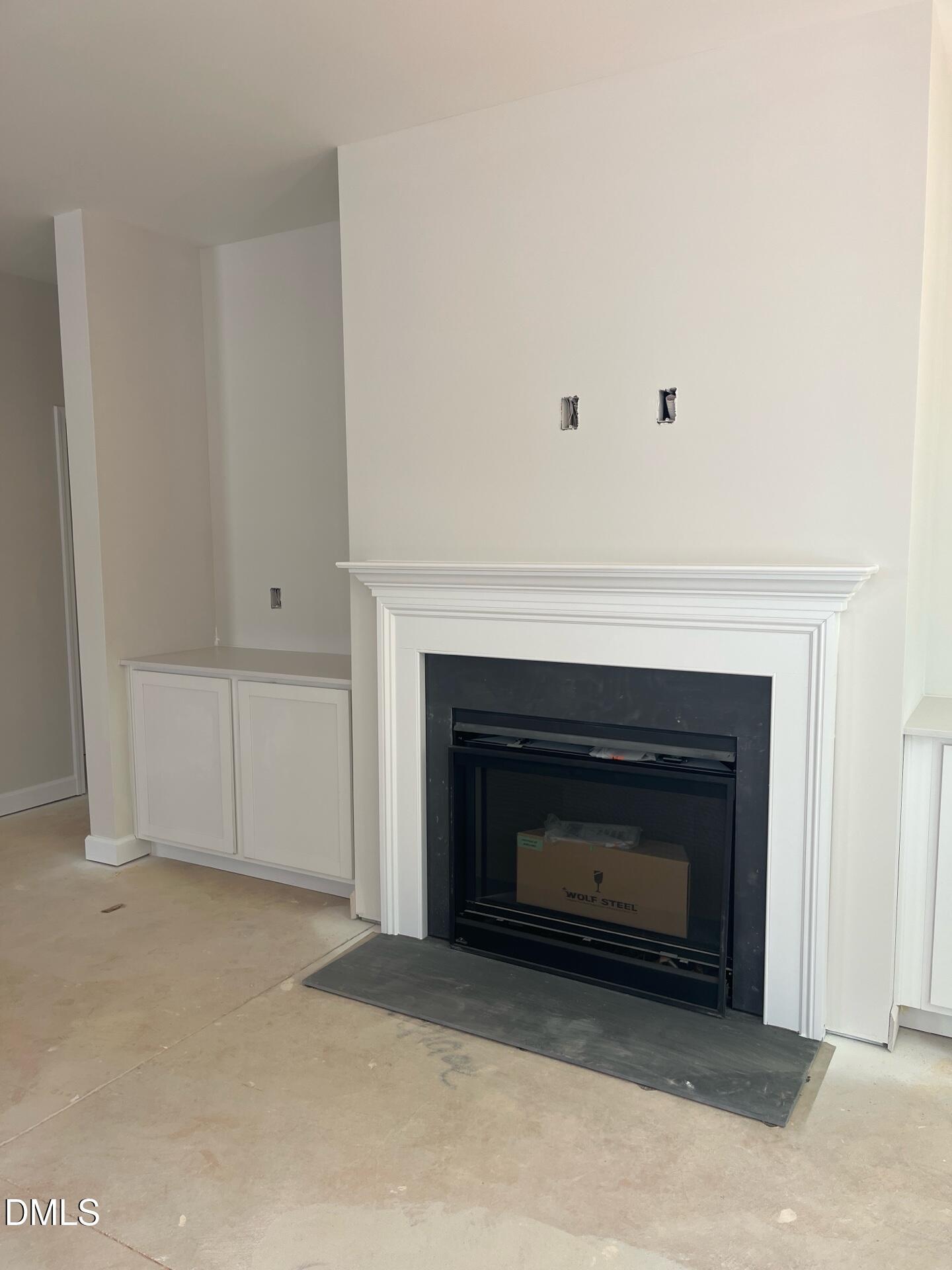 Elegant white fireplace with built-in cabinets in family room of Davidson Homes Ashport G, Wake Forest, NC