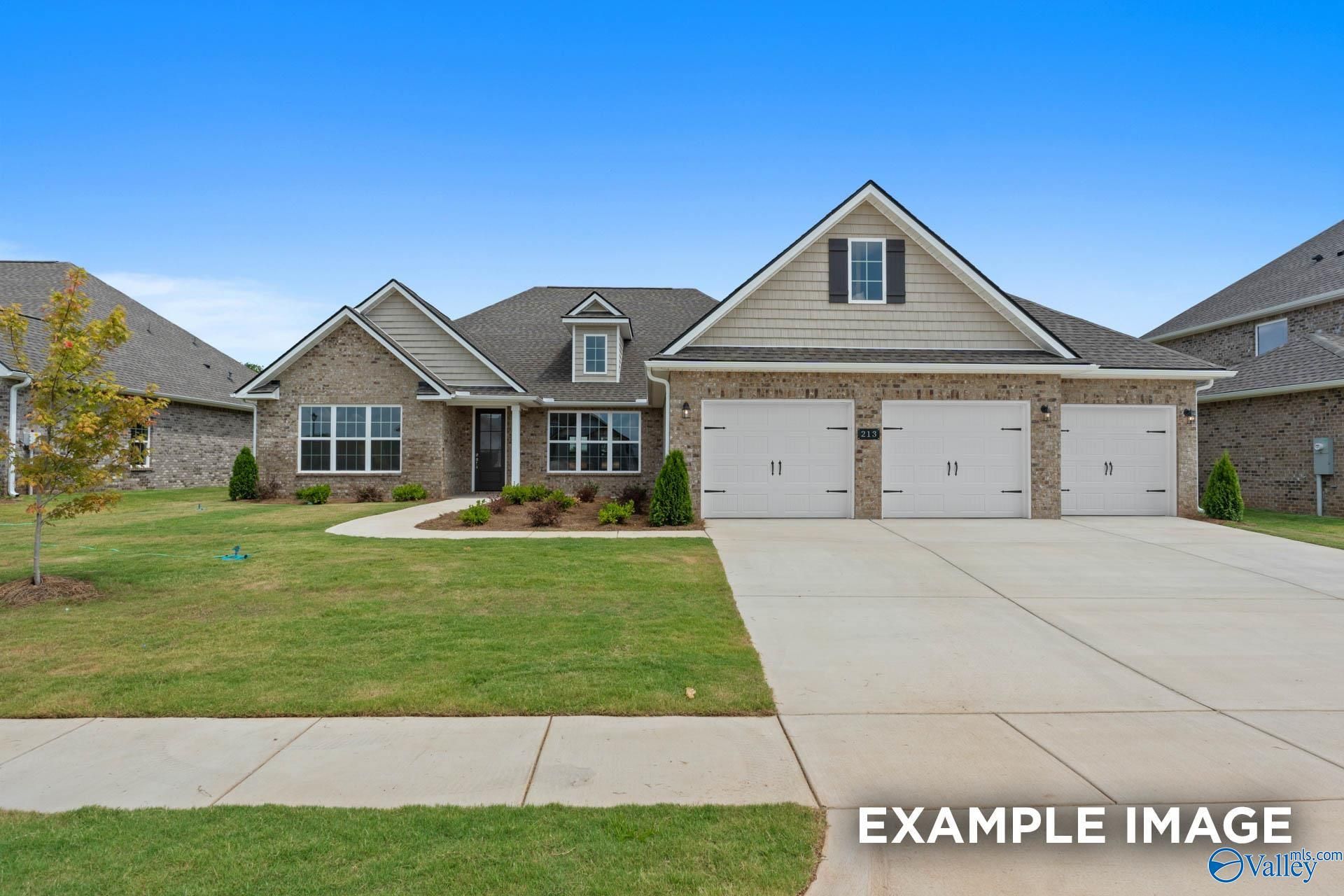 Beige brick single-story home with 3-car garage, gabled roof, manicured lawn in Riverton Preserve, Huntsville, Alabama - Davidson Homes The Oxford