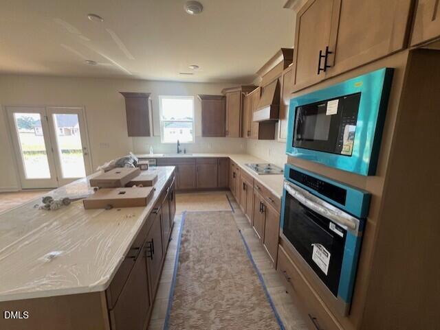 Modern kitchen with large island and built-in appliances in The Hickory II B floor plan at Retreat at North Main, Lillington.
