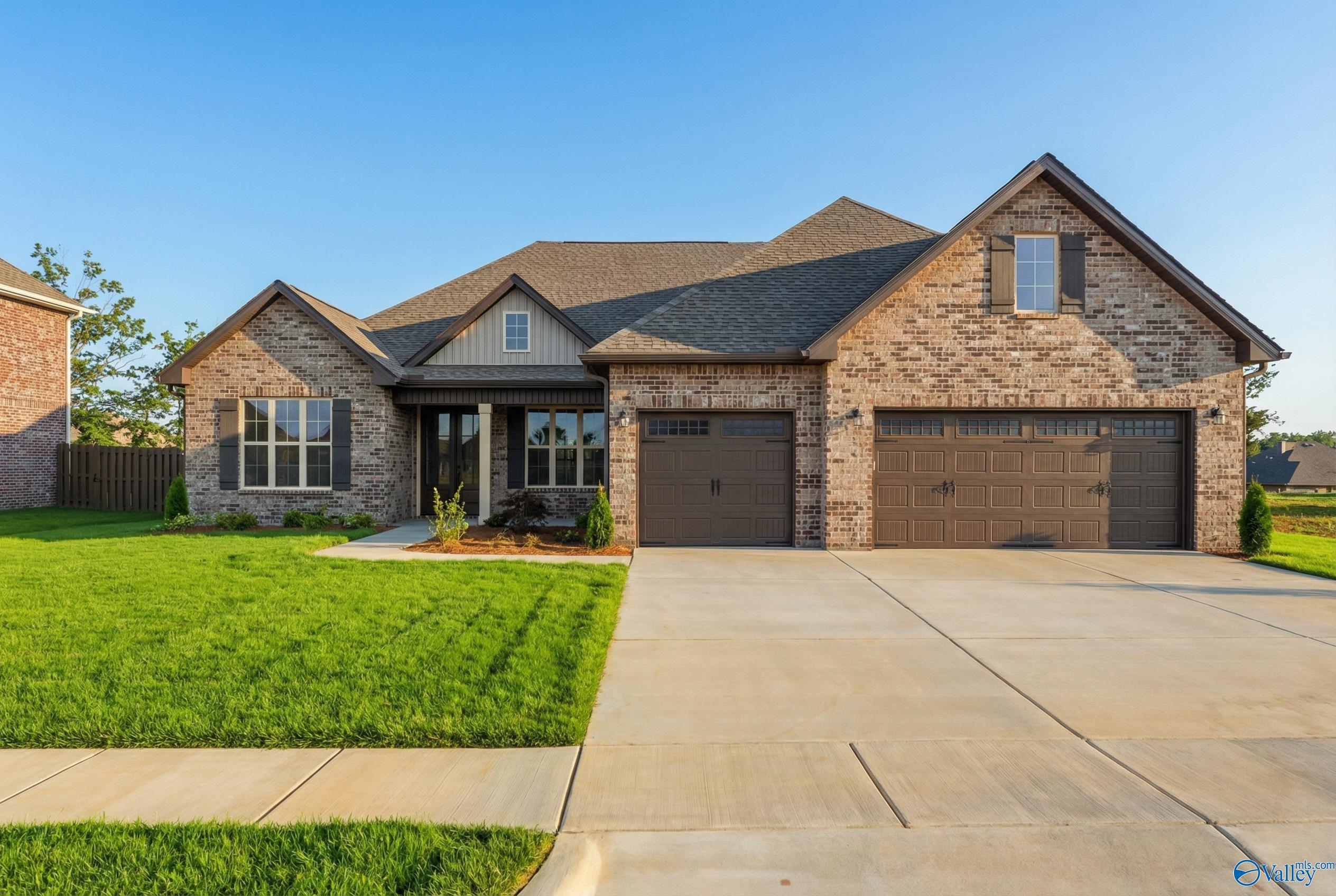 Modern brick ranch home with 3-car garage, covered entry, and manicured lawn in Briercreek, Meridianville, Alabama by Davidson Homes The Finleigh