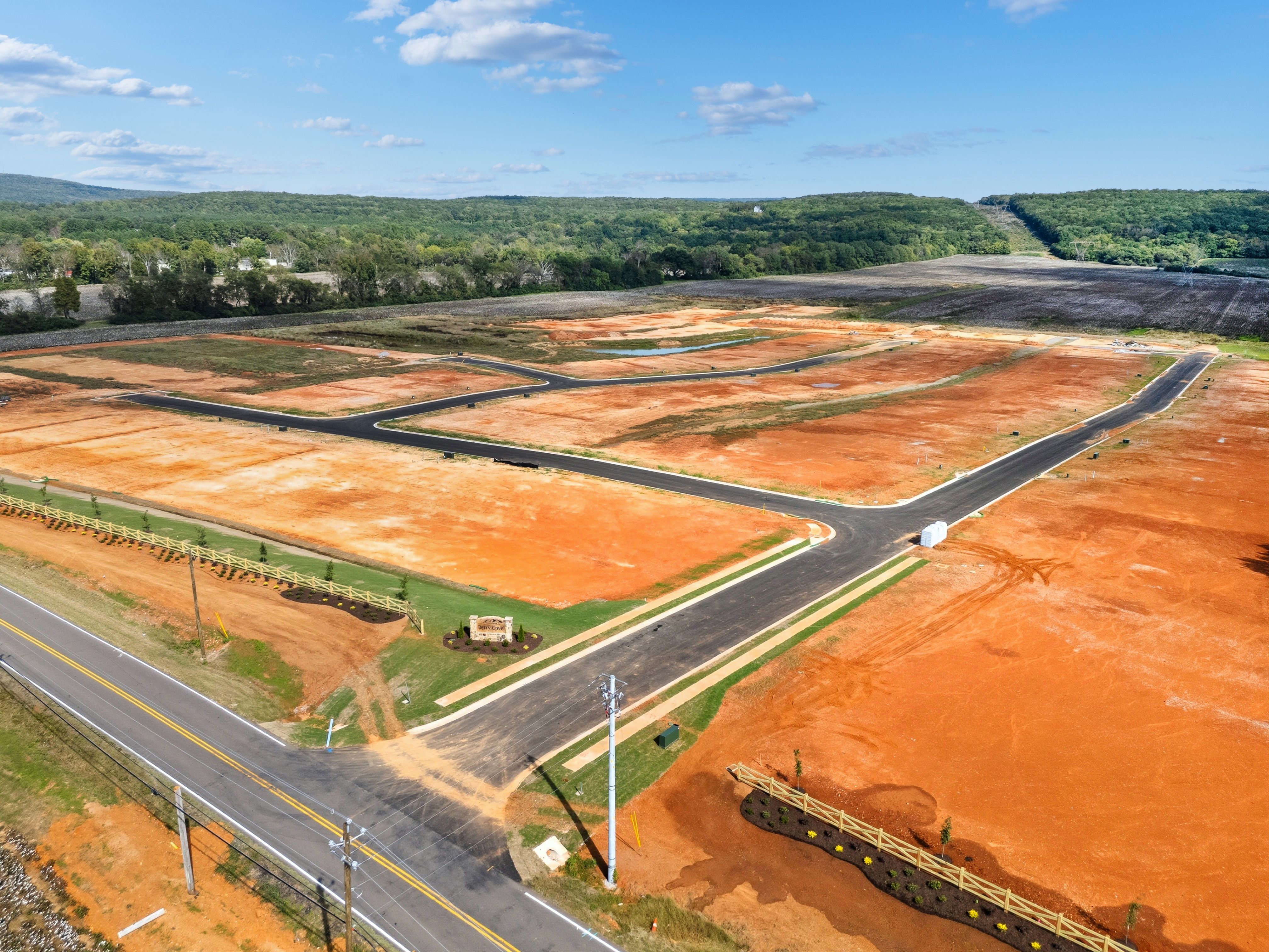 Aerial view of Berry Cove development in New Market Alabama featuring red clay lots roads and wooded surroundings