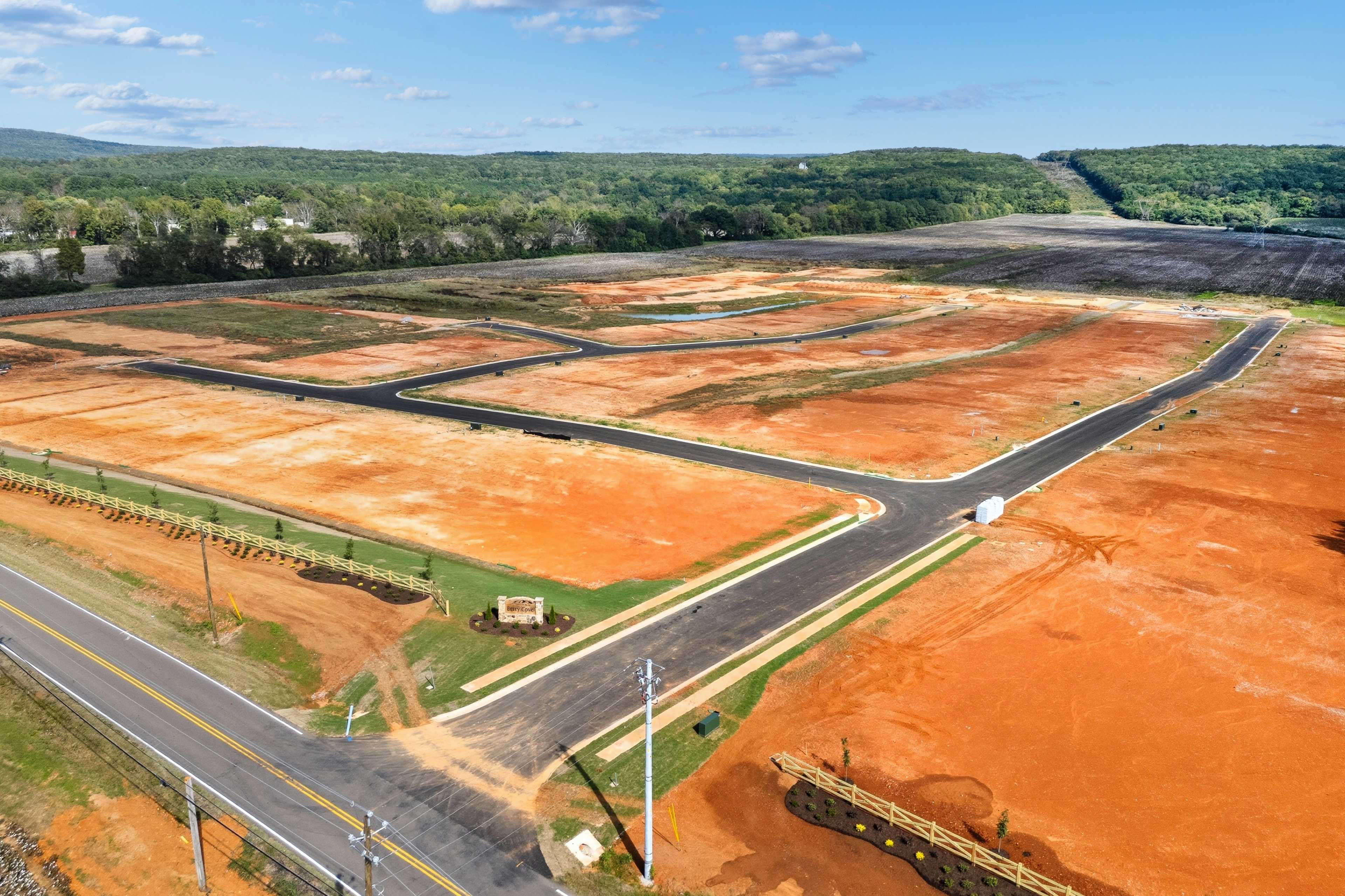 Aerial view of Berry Cove development in New Market Alabama featuring red clay lots roads and wooded surroundings