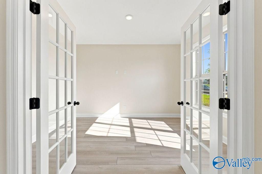 Bright home office or bonus room with French doors in The Madison A floor plan at Cain Park, Hartselle, Alabama.