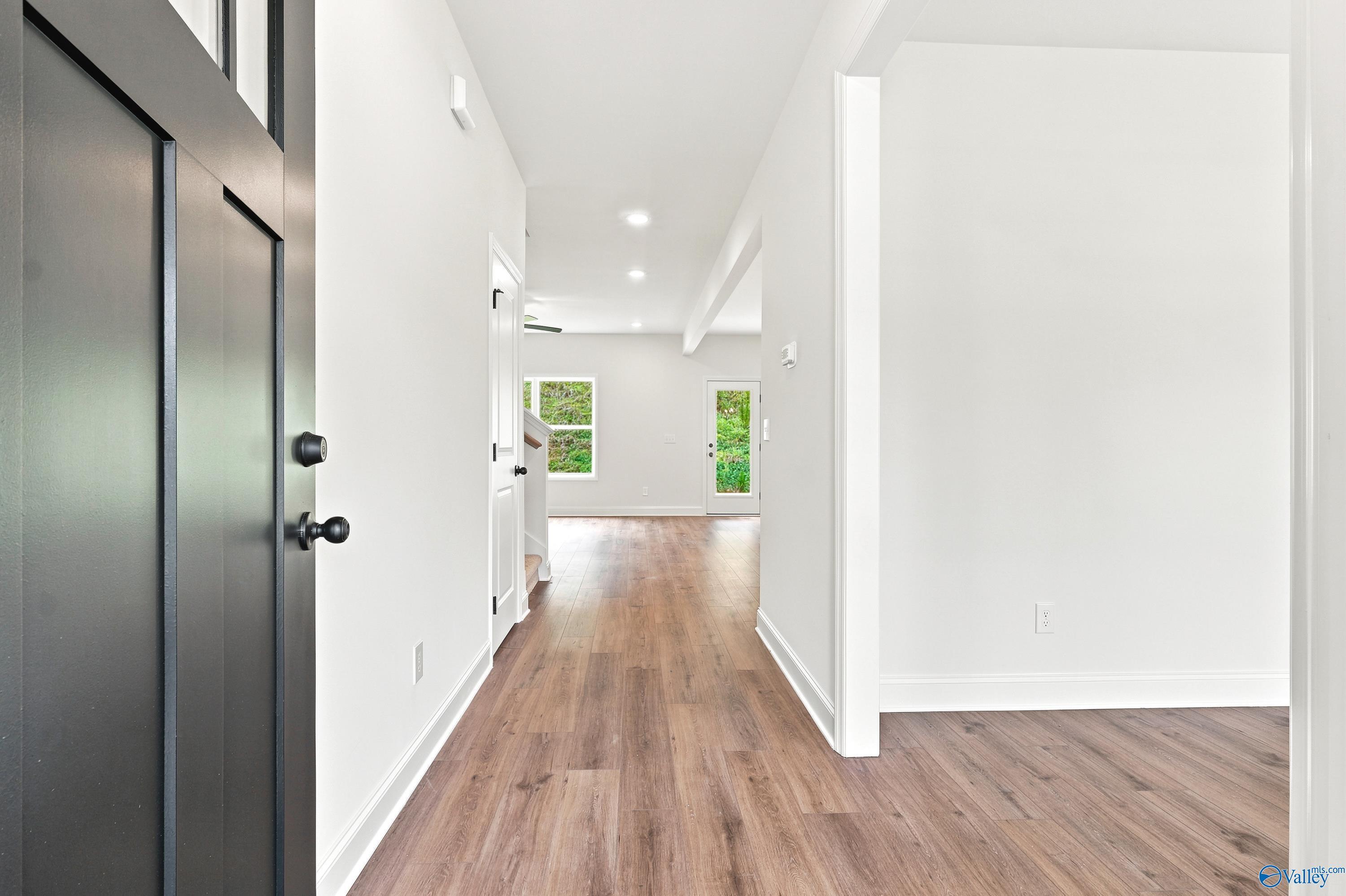 Bright entryway with wood-style flooring leading to open living space in The Shelby D floor plan at Noble Ridge, Cullman.