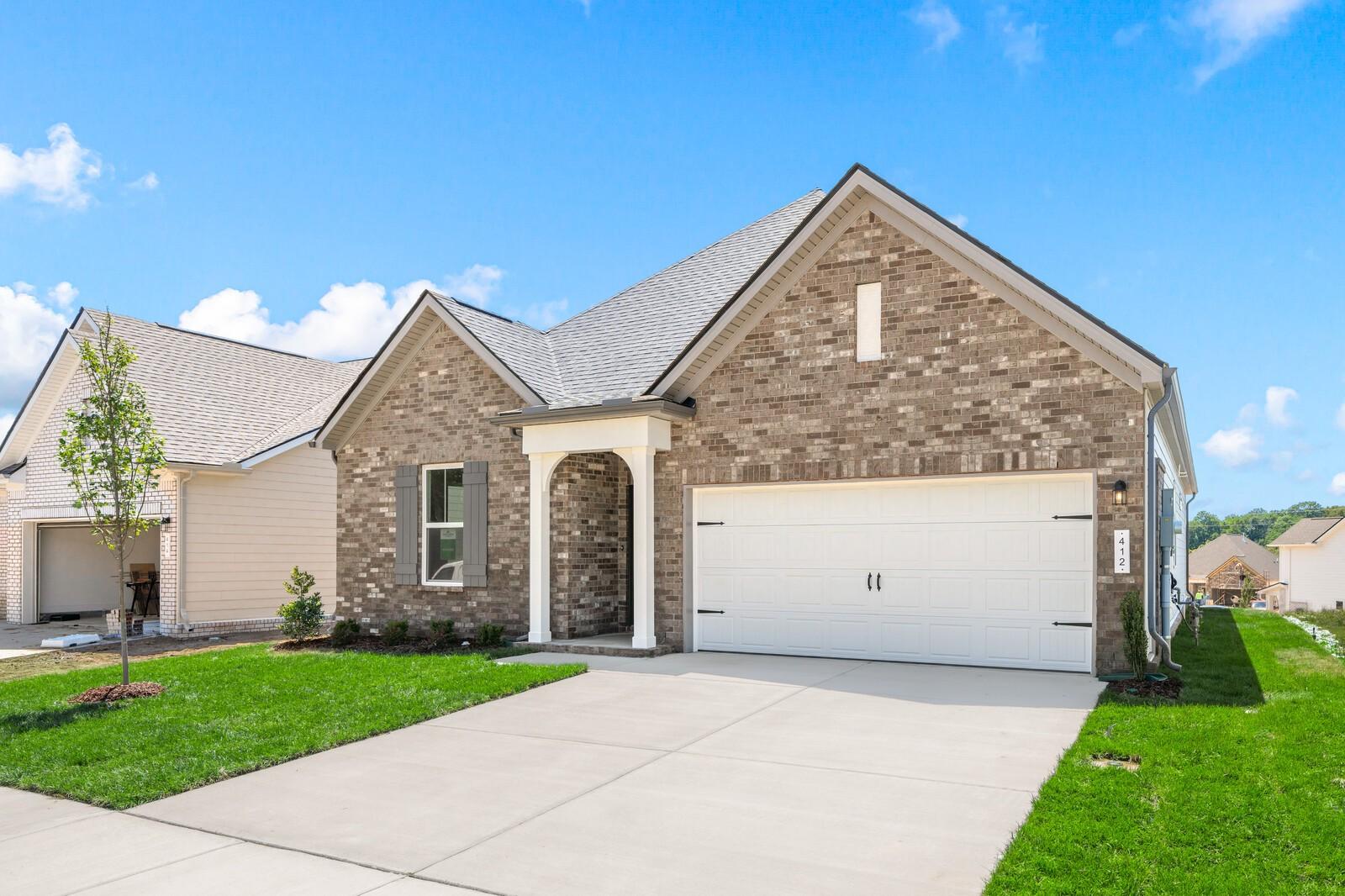 The Cottonwood E floor plan by Davidson Homes: 1-story brick exterior with 2-car garage in Woods Crossing, Gallatin, TN.