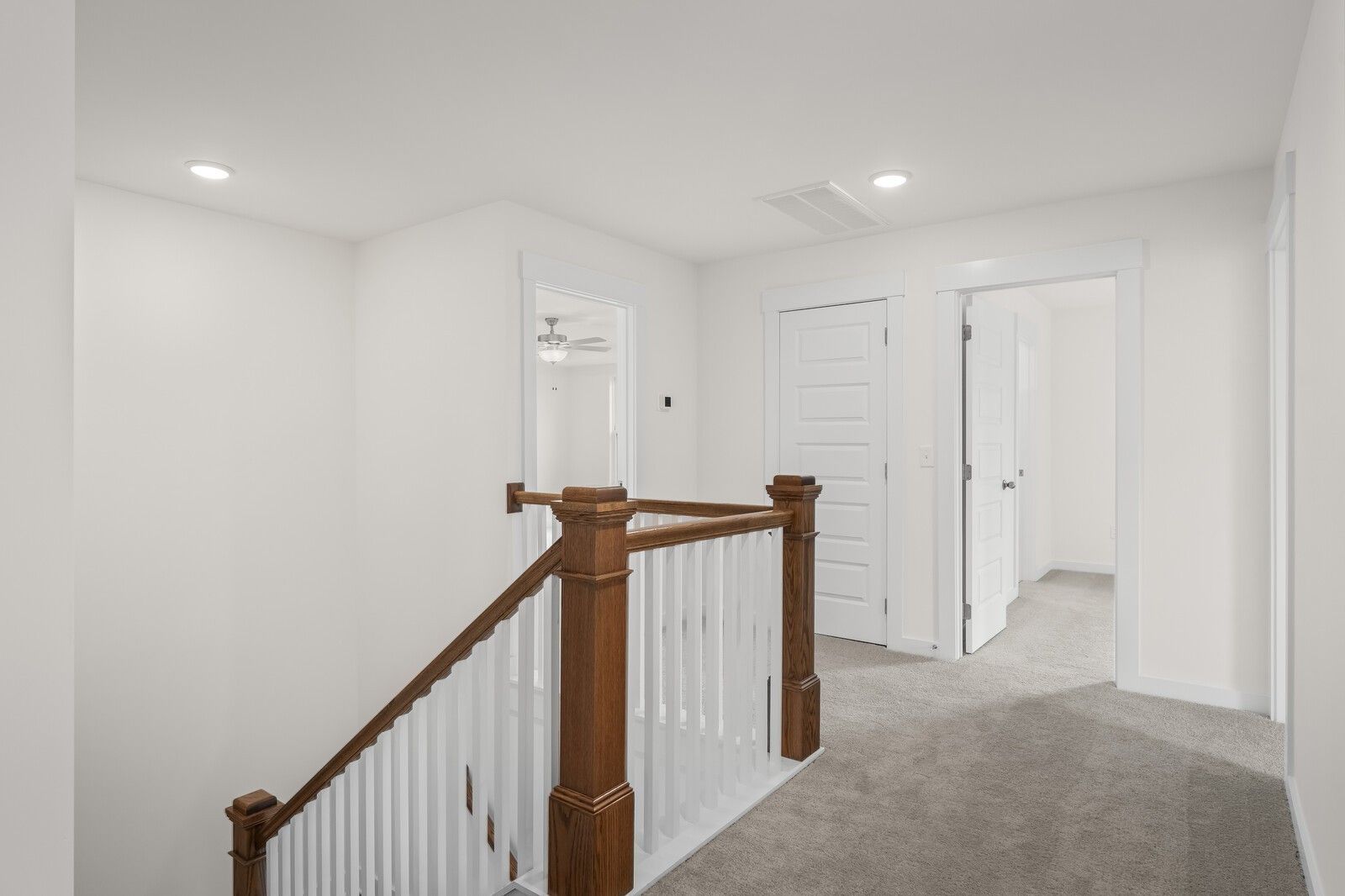 Bright second-floor landing with wood railing in The Henry C floor plan at Benders Cove, Mt. Juliet, Tennessee.