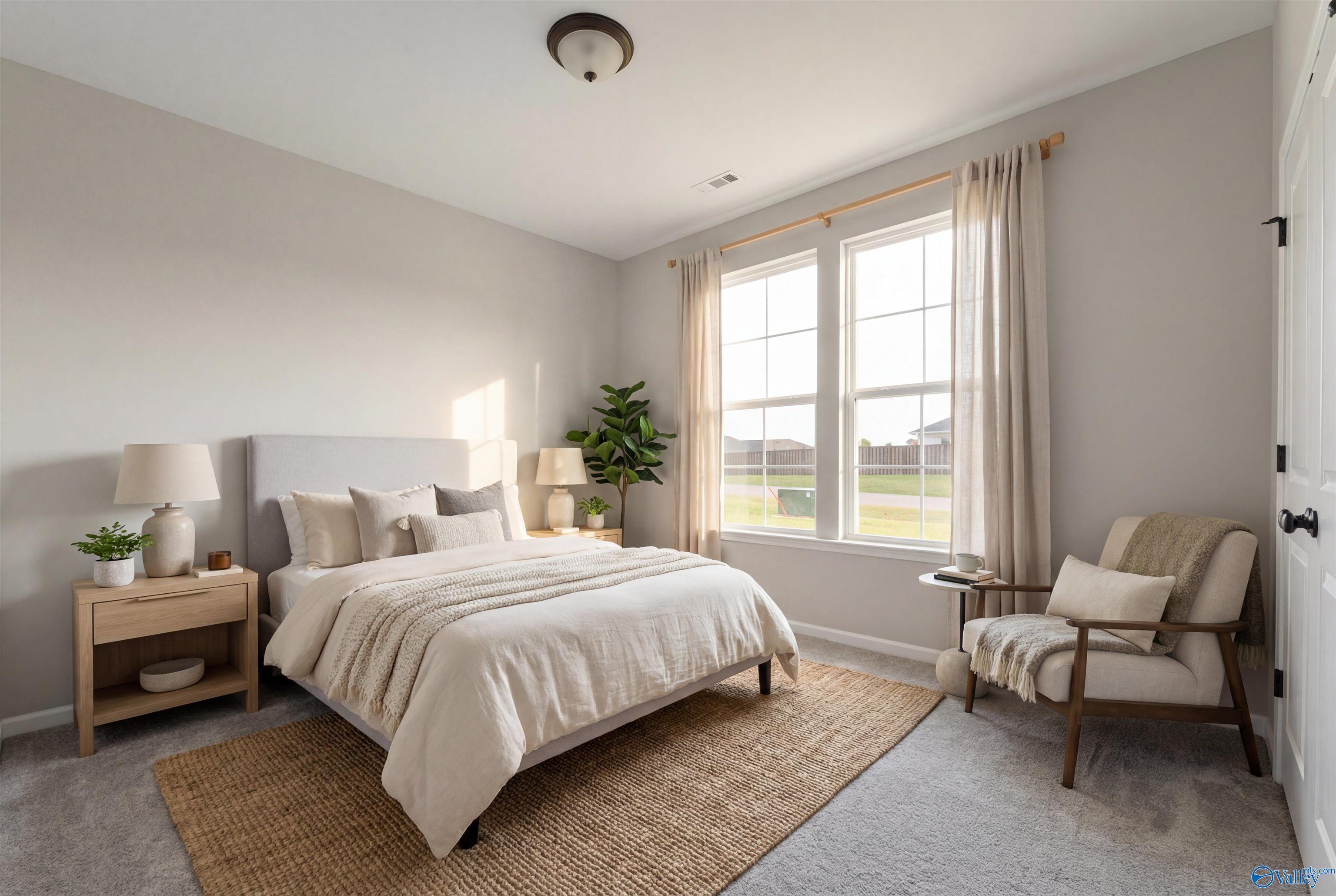 Serene bedroom with neutral tones, king bed, large windows overlooking yard, potted plant, and armchair in Davidson Homes The Phoenix, Fayetteville, TN