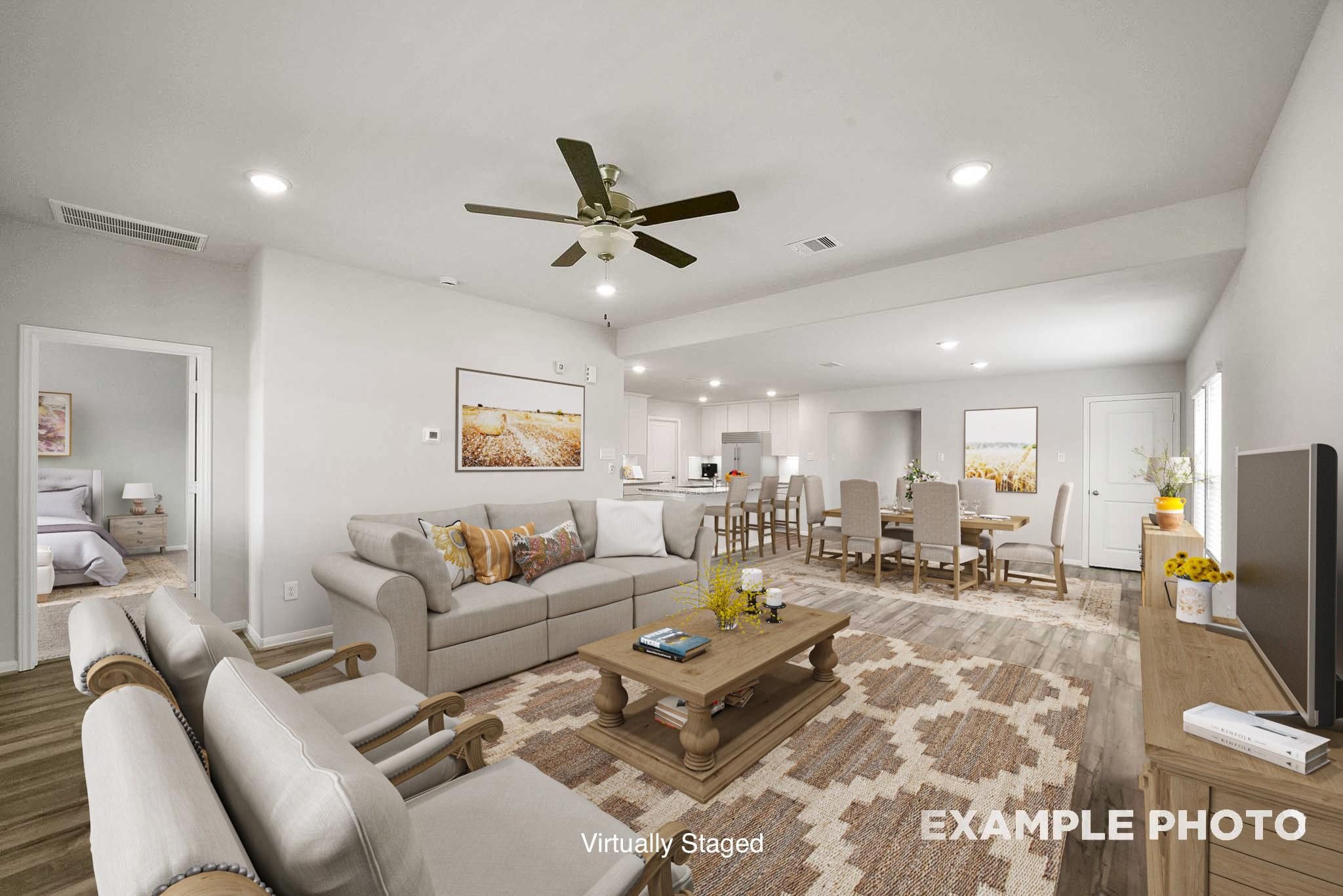 Open-concept living room with yellow sofa, dining table, and kitchen island in Davidson Homes The Tierra B, Beasley, Texas