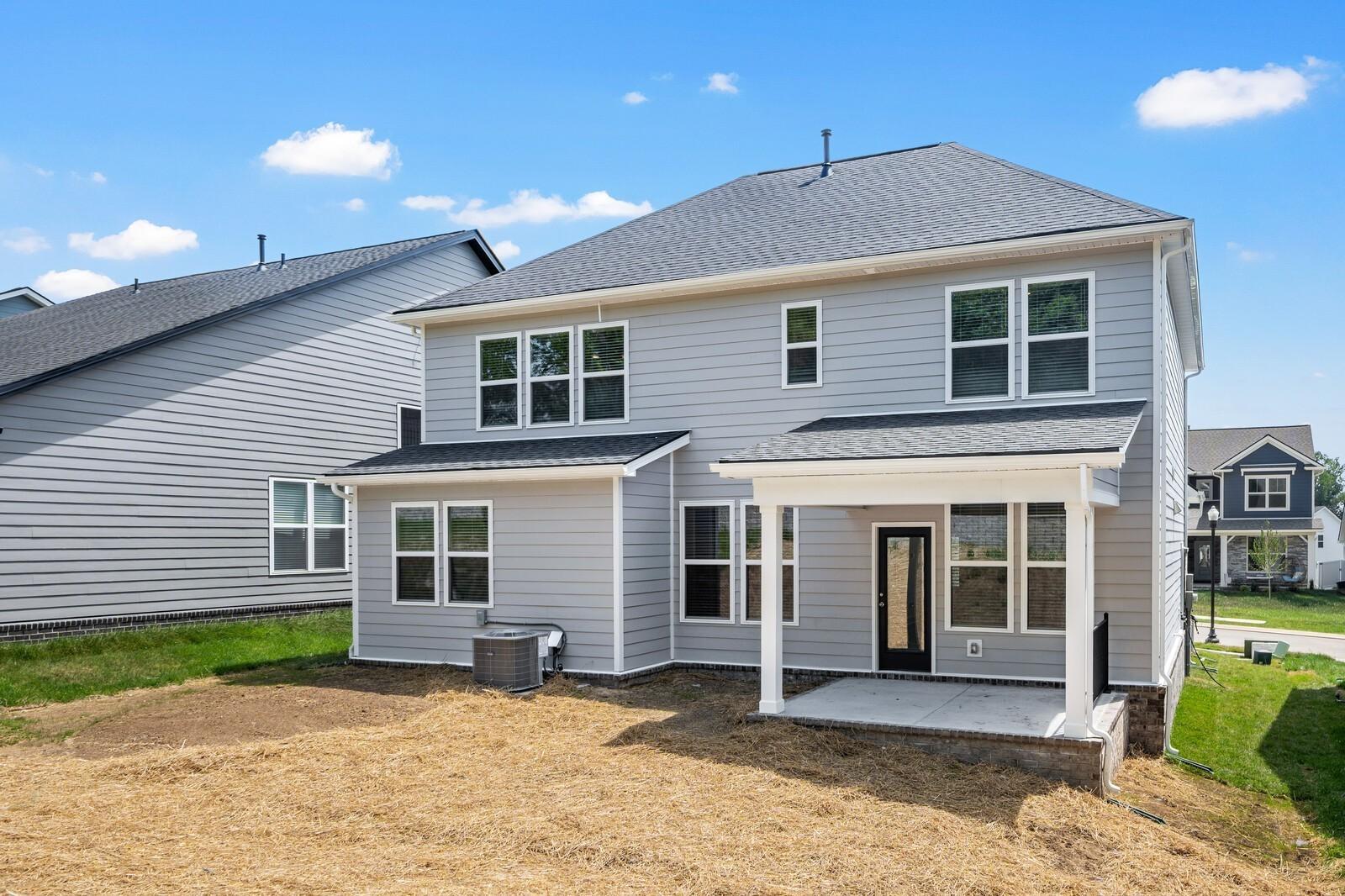 Back exterior view of The Willow floor plan by Davidson Homes featuring a covered patio in Woods Crossing, Gallatin, TN.