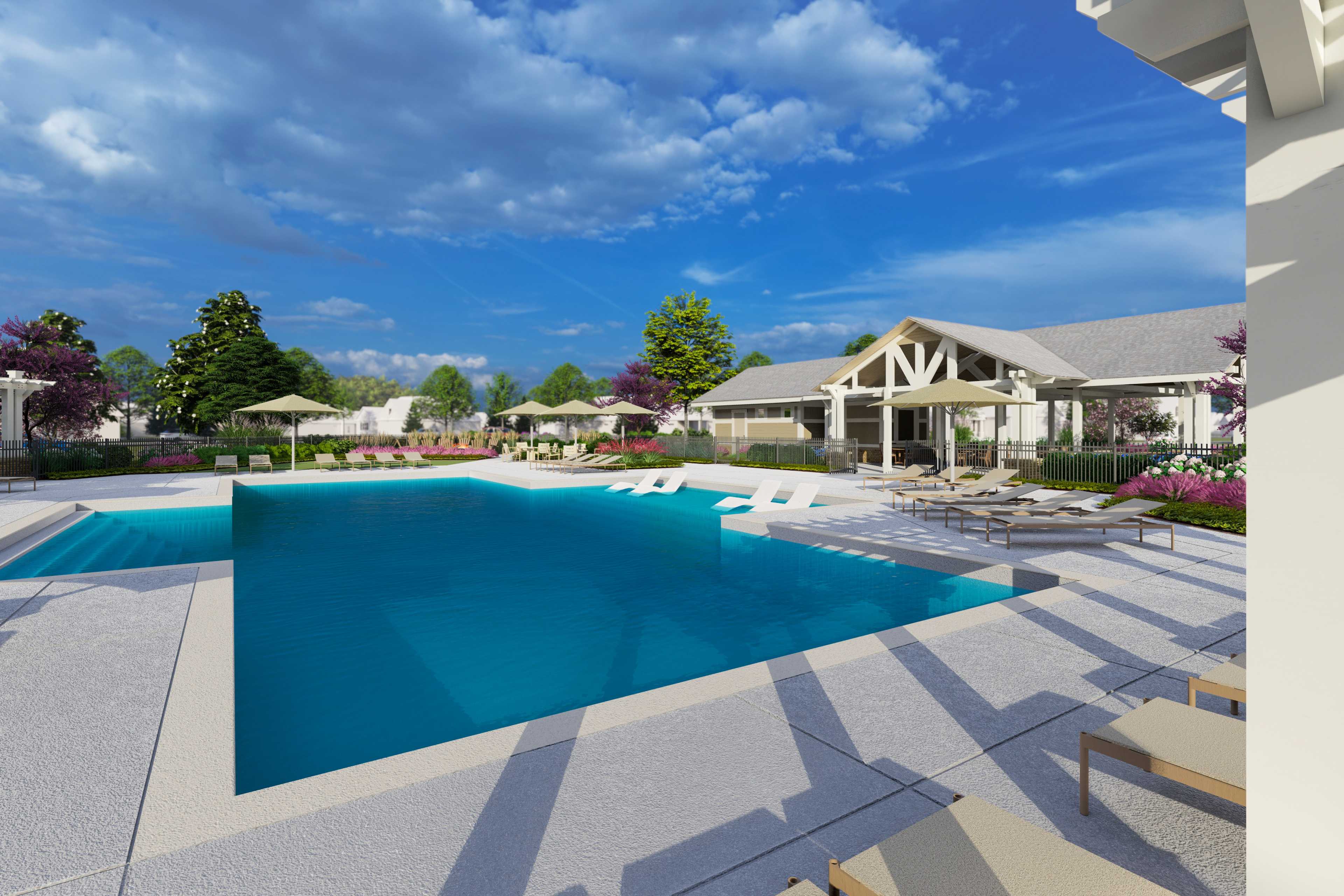 Resort-style swimming pool at Creekside in Harvest Alabama with lounge chairs umbrellas and pergola clubhouse