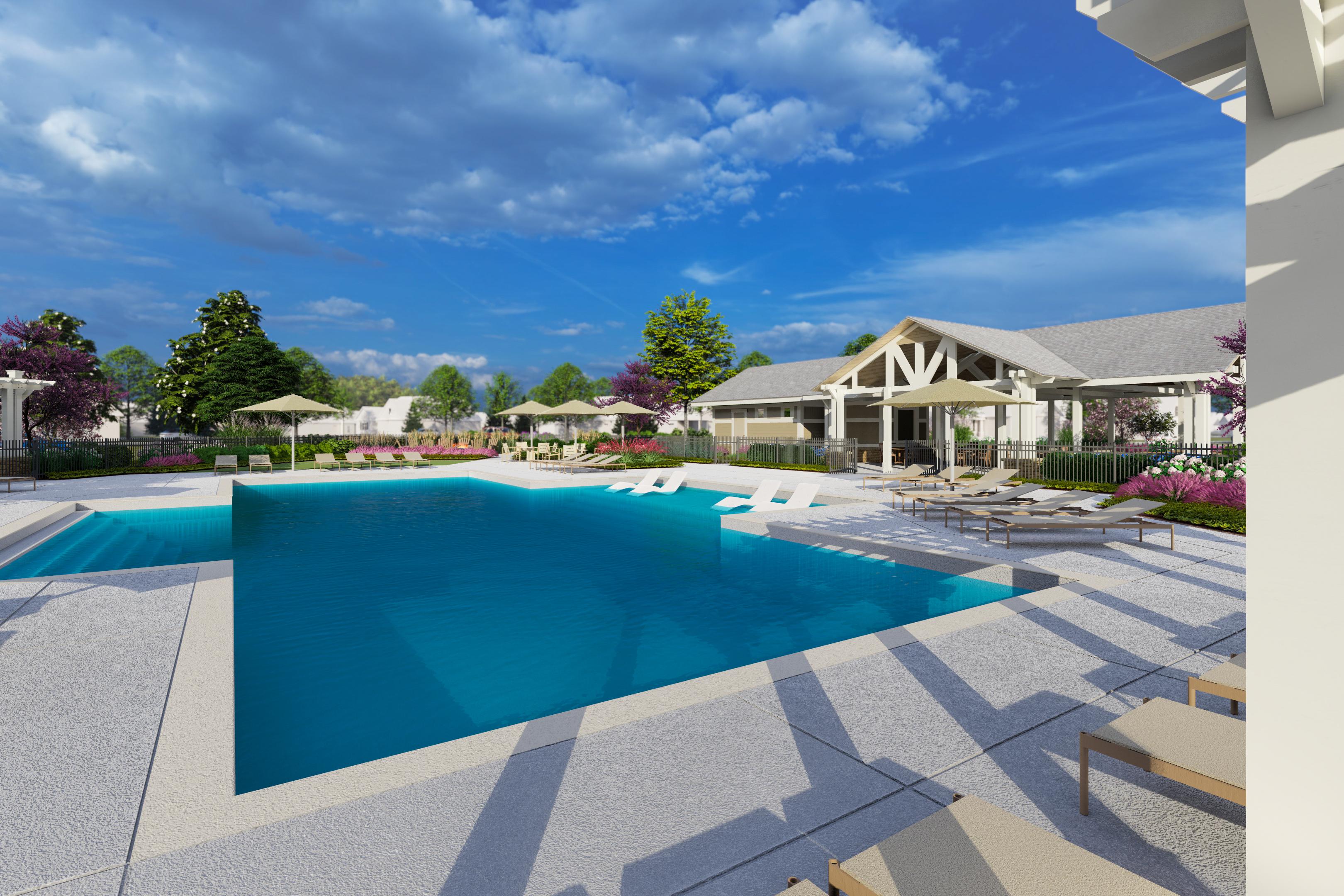 Resort-style swimming pool at Creekside in Harvest Alabama with lounge chairs umbrellas and pergola clubhouse