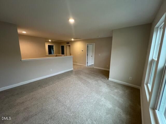 Spacious carpeted loft with half wall and natural light in Davidson Homes The Willow D, Wellers Knoll, Lillington, North Carolina