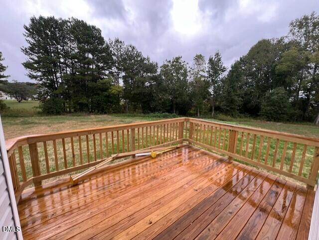 Wooden deck overlooking private backyard with wooded views at The Willow D by Davidson Homes in Wellers Knoll, Lillington, NC