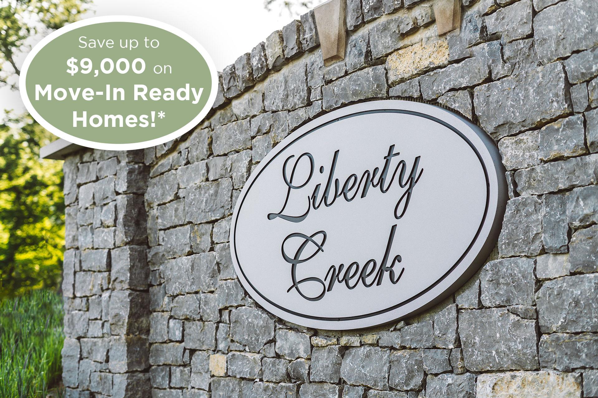 Liberty Creek community sign on stone wall in Gallatin TN with $9,000 move-in ready homes savings promo