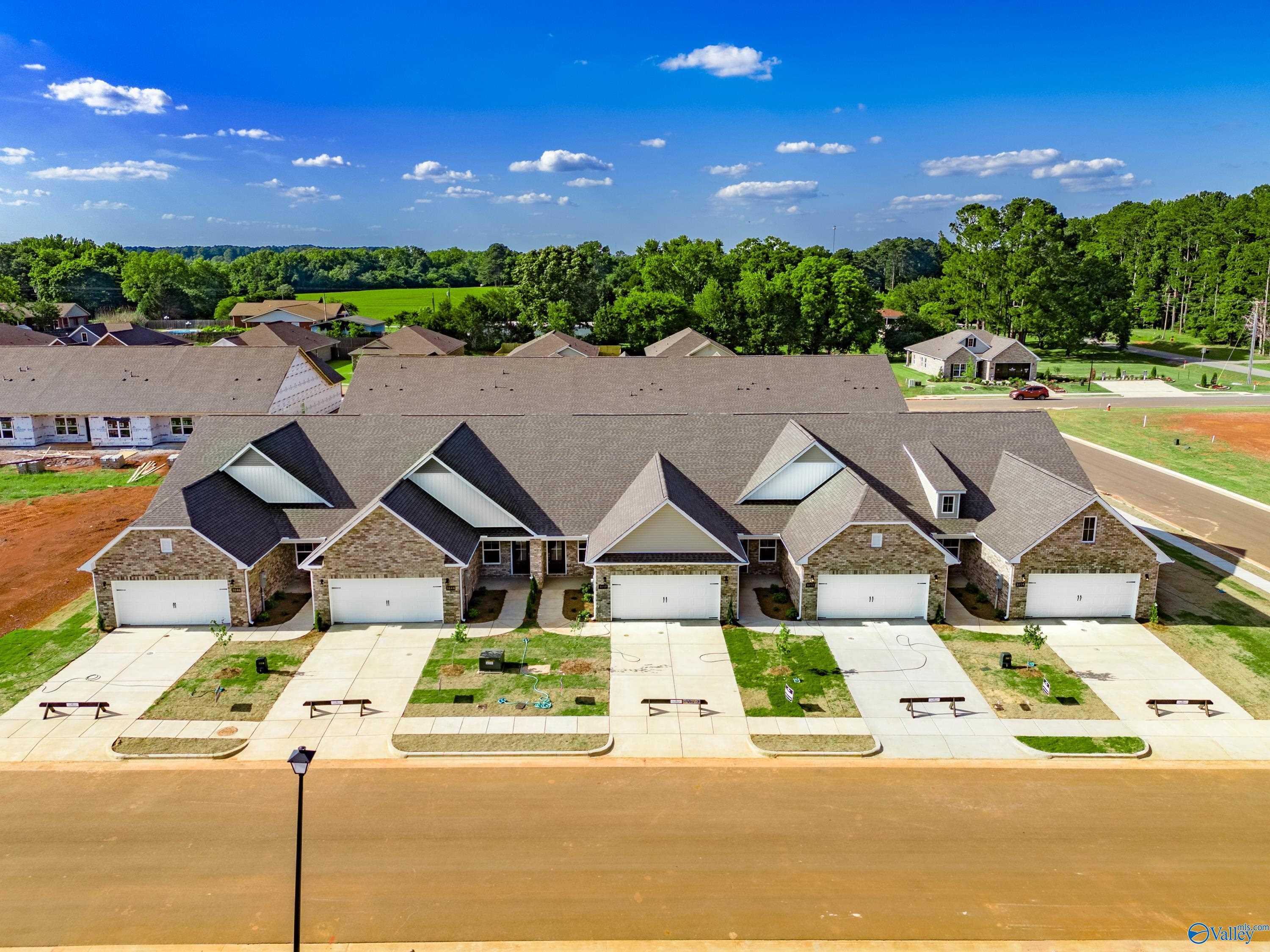 Aerial view of row of modern The Cumberland 3-bedroom homes with 2-car garages in The Retreat at Hollon Meadow, Decatur, Alabama