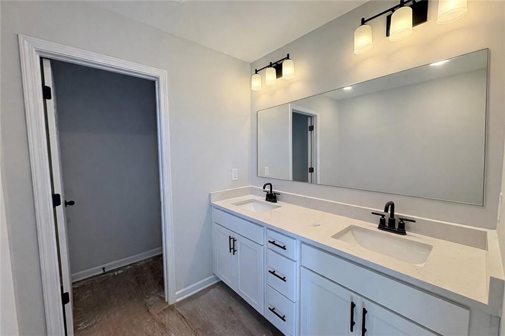 Modern master bathroom featuring double vanity, white shaker cabinets, quartz countertop in Davidson Homes The Wake E, Cumming, GA