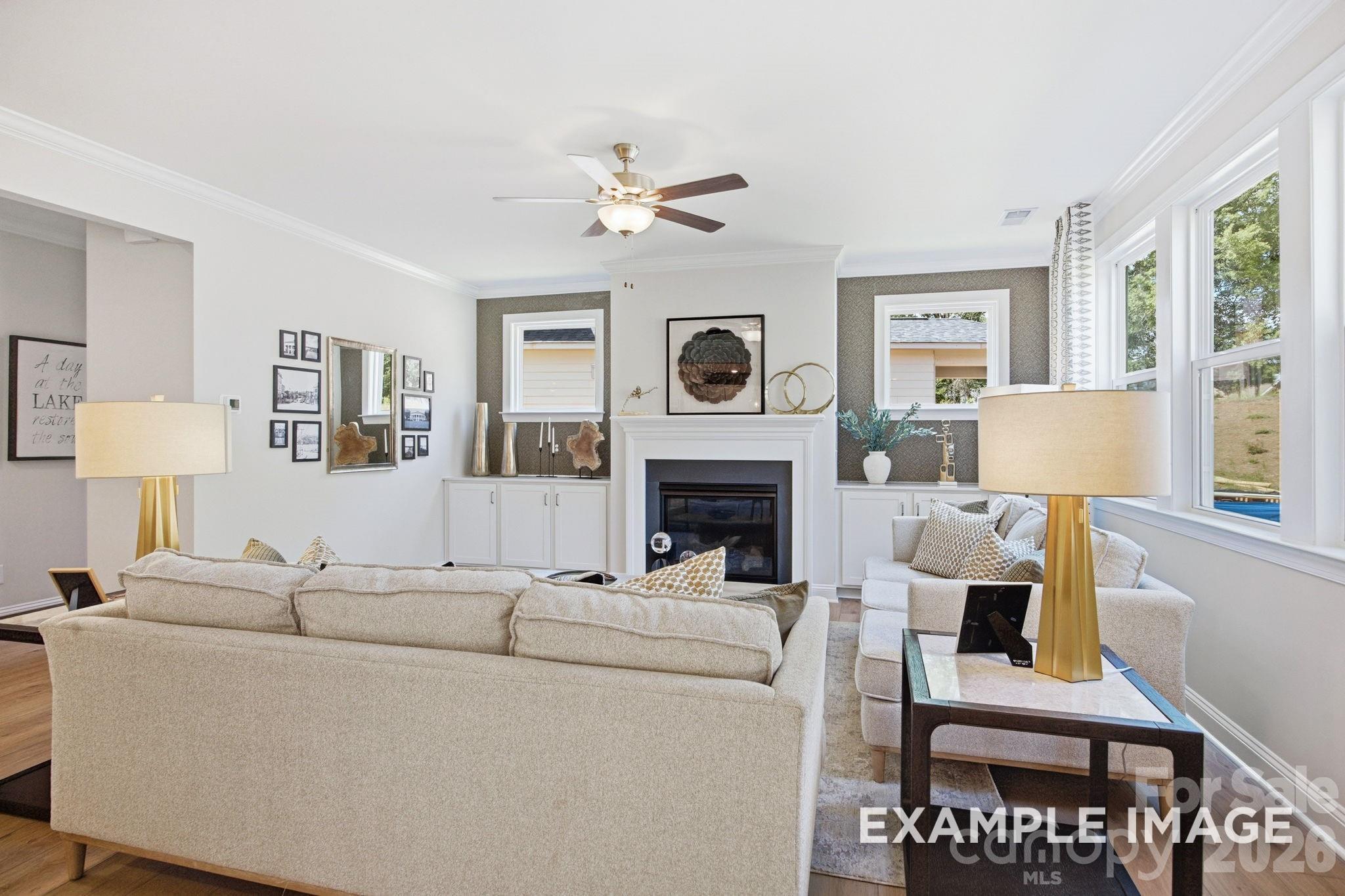 Bright living room with fireplace and built-ins in The Hickory B II floor plan by Davidson Homes in Windgate, Mooresville.