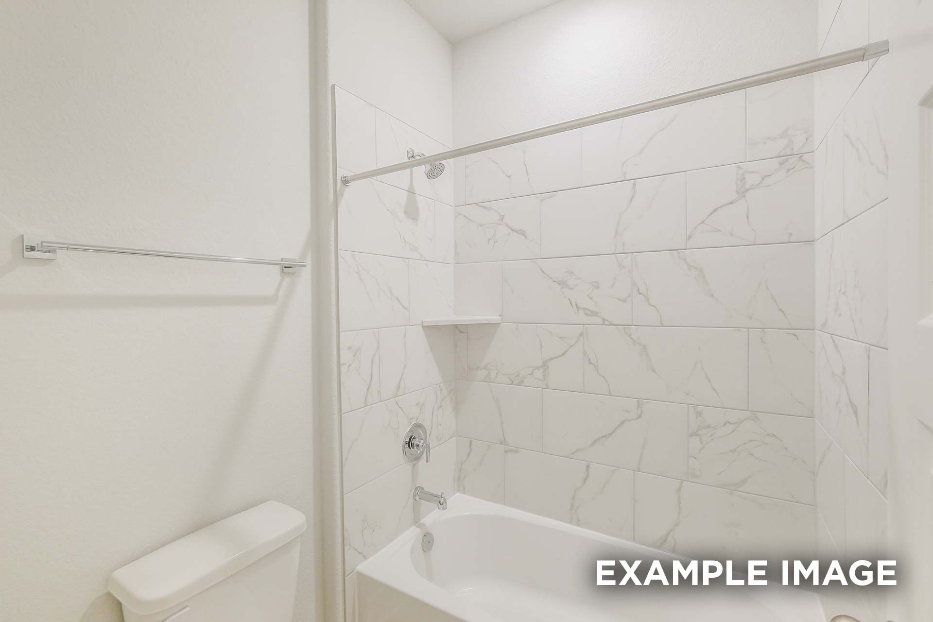 Modern bathroom in The Luna K with white marble-look tiles, alcove tub, shower curtain rod, and built-in shelf