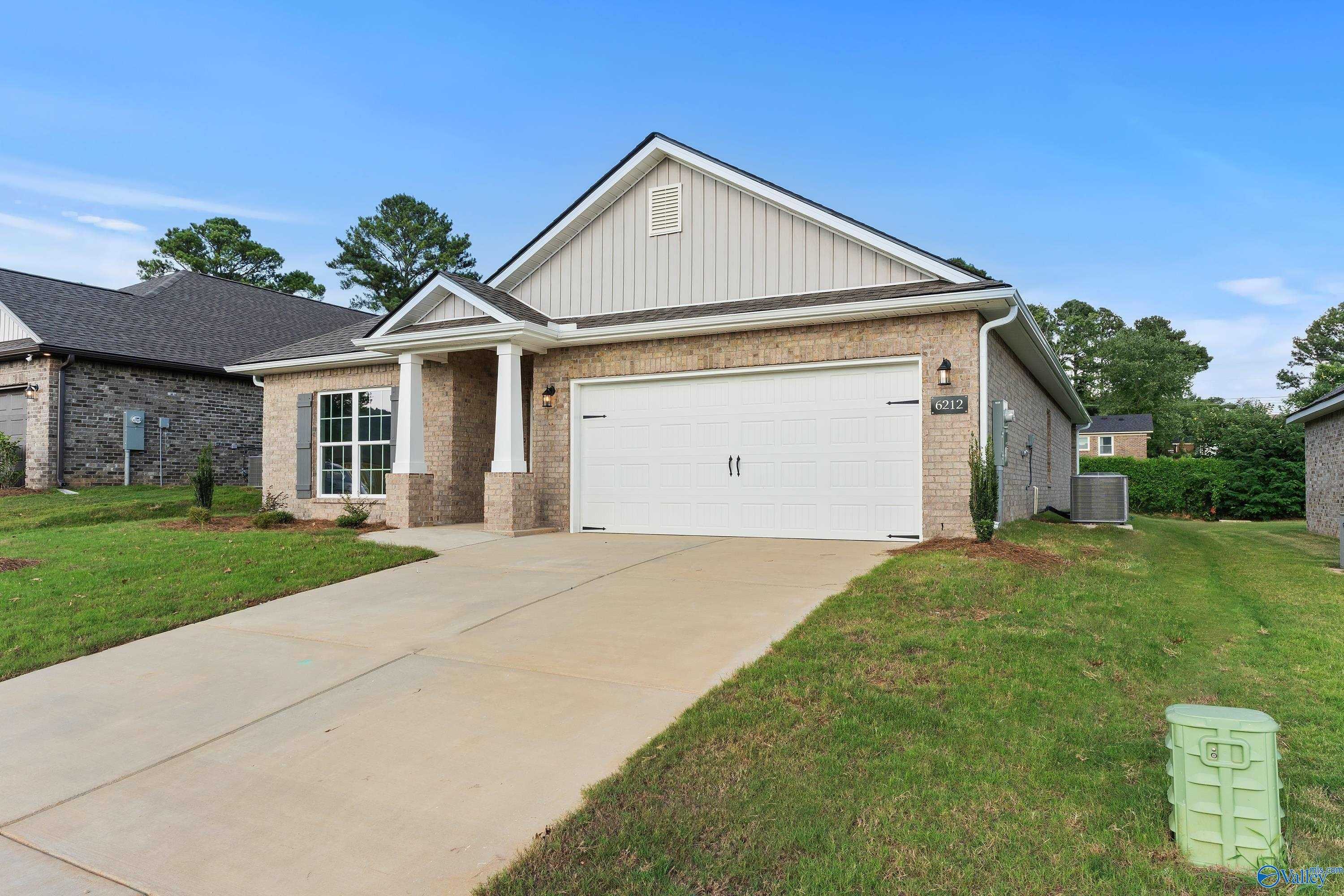 Exterior of beige brick The Daphne C 4-bedroom home with 2-car garage in Jaguar Hills, Huntsville, Alabama by Davidson Homes