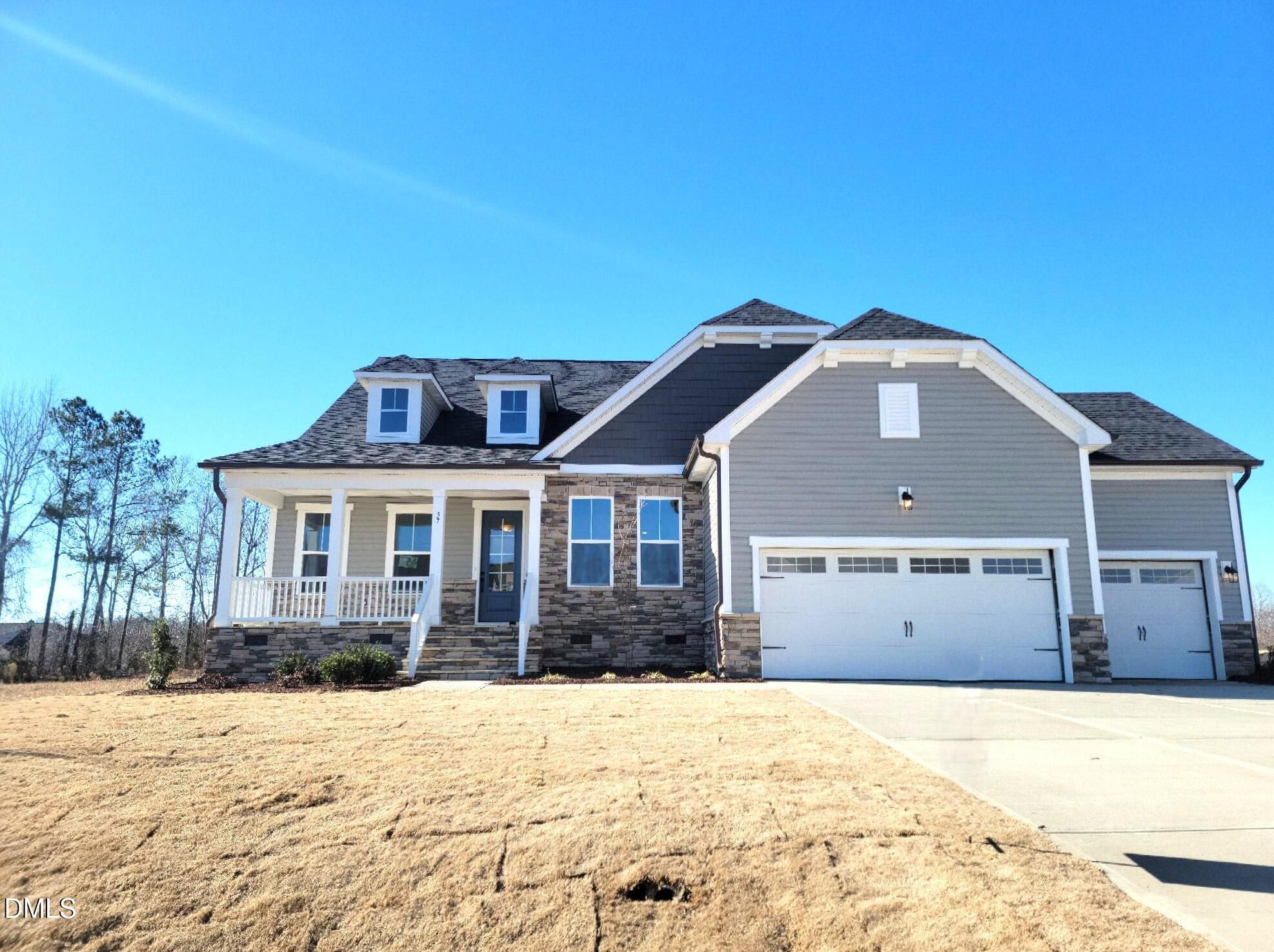 Gray 1-story home with 3-car garage, covered front porch, and stone accents in Tobacco Road, Angier, NC - Davidson Homes Magnolia B