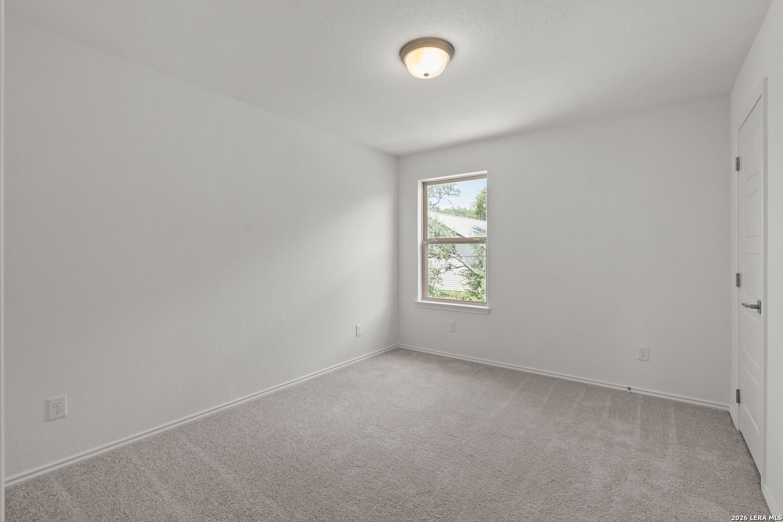 Bright, neutral bedroom with plush carpeting in The Gillian C floor plan at Meadows at Oak Creek, San Antonio, Texas.