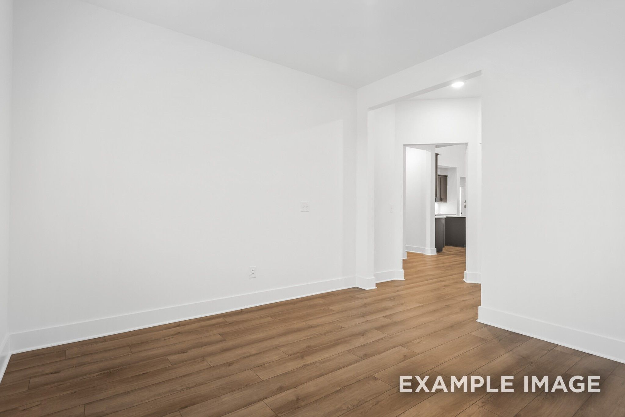 Empty bedroom with hardwood floors and adjacent bathroom in Davidson Homes Ridgeport C, Gallatin, Tennessee