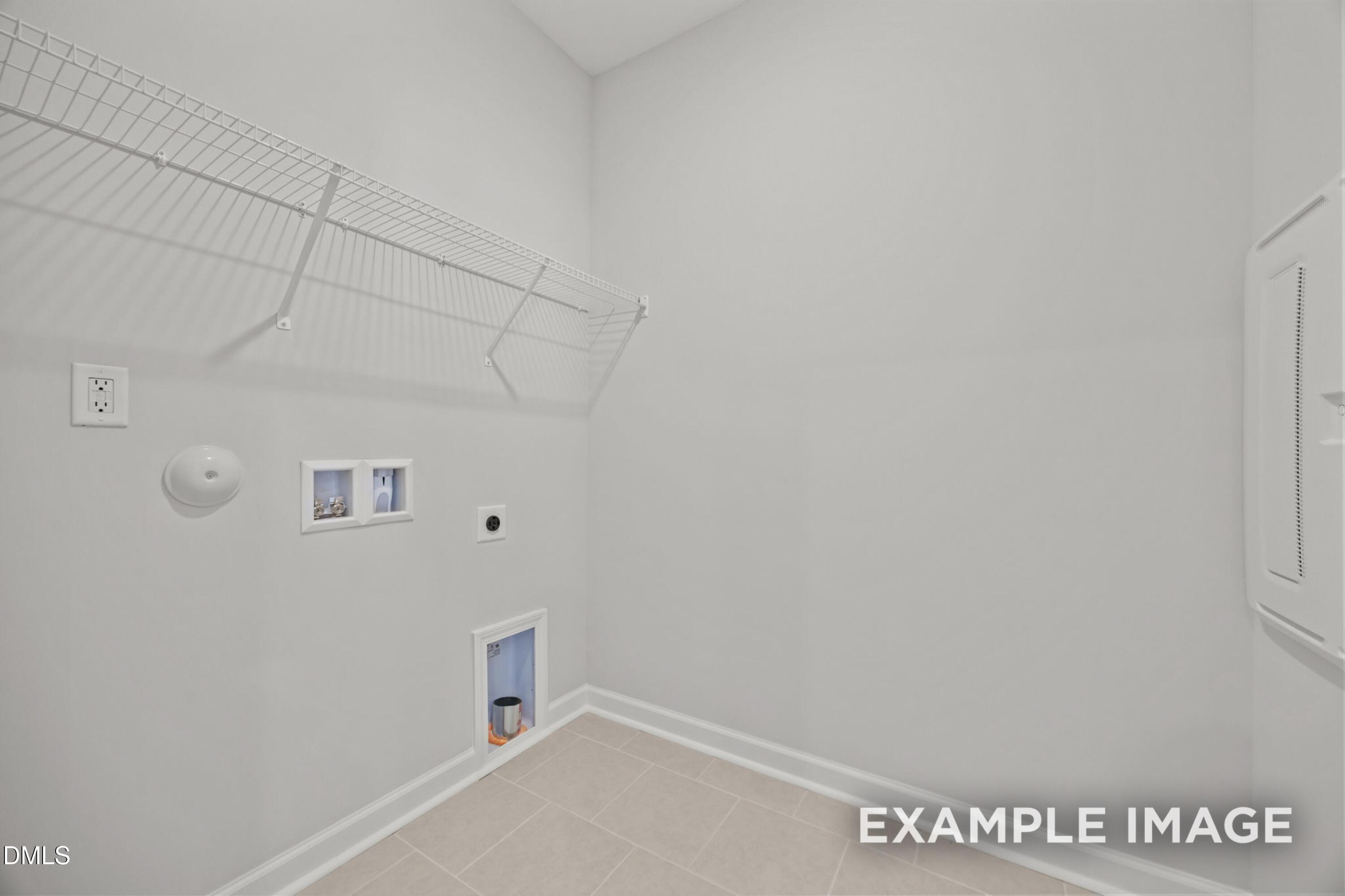 Laundry room with wire shelving and utility hookups in The Alexander B floor plan at Forestville Yard, Knightdale, NC.