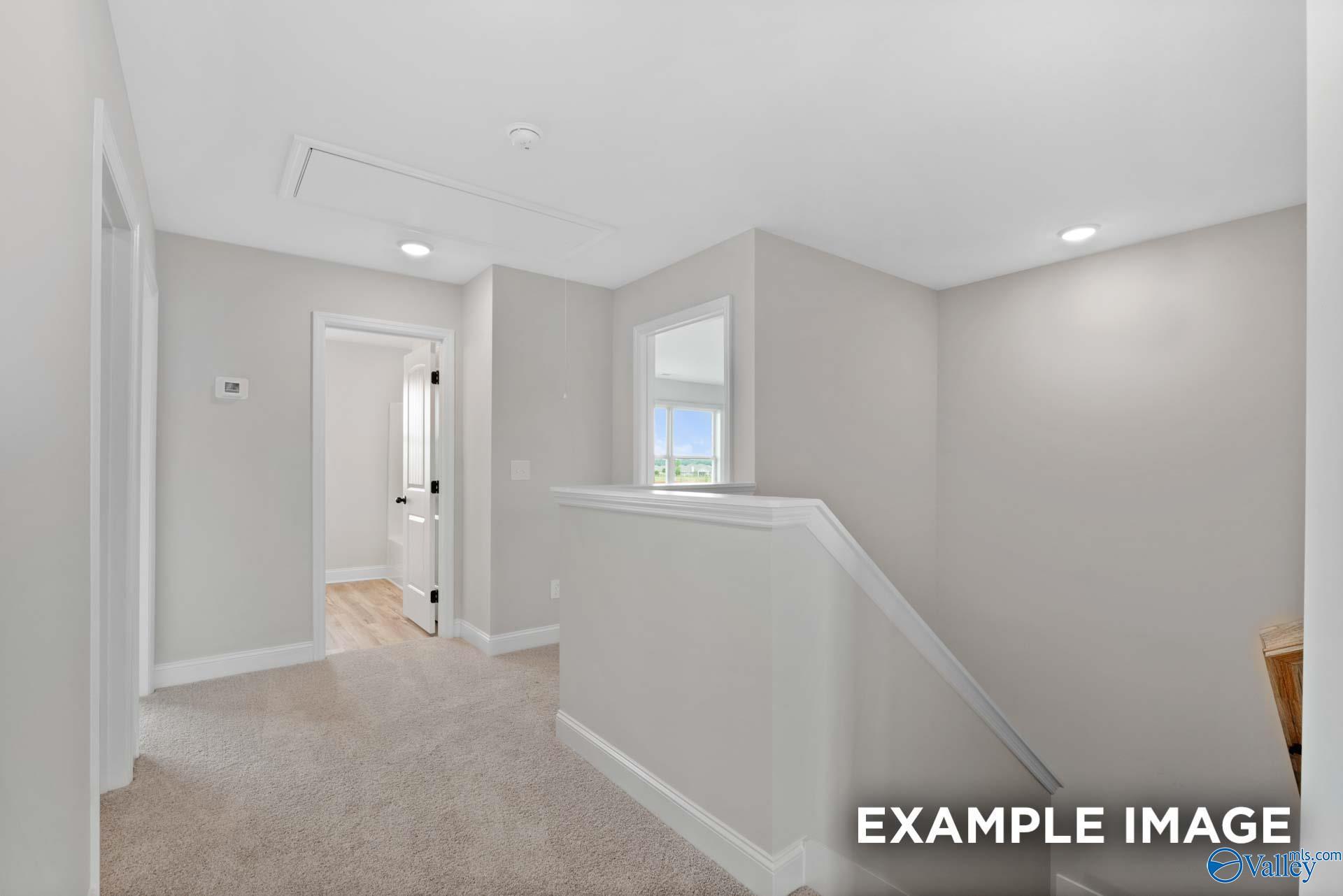 Bright second-floor landing with carpeted hallway in The Shelby B floor plan by Davidson Homes, Jaguar Hills, Huntsville.