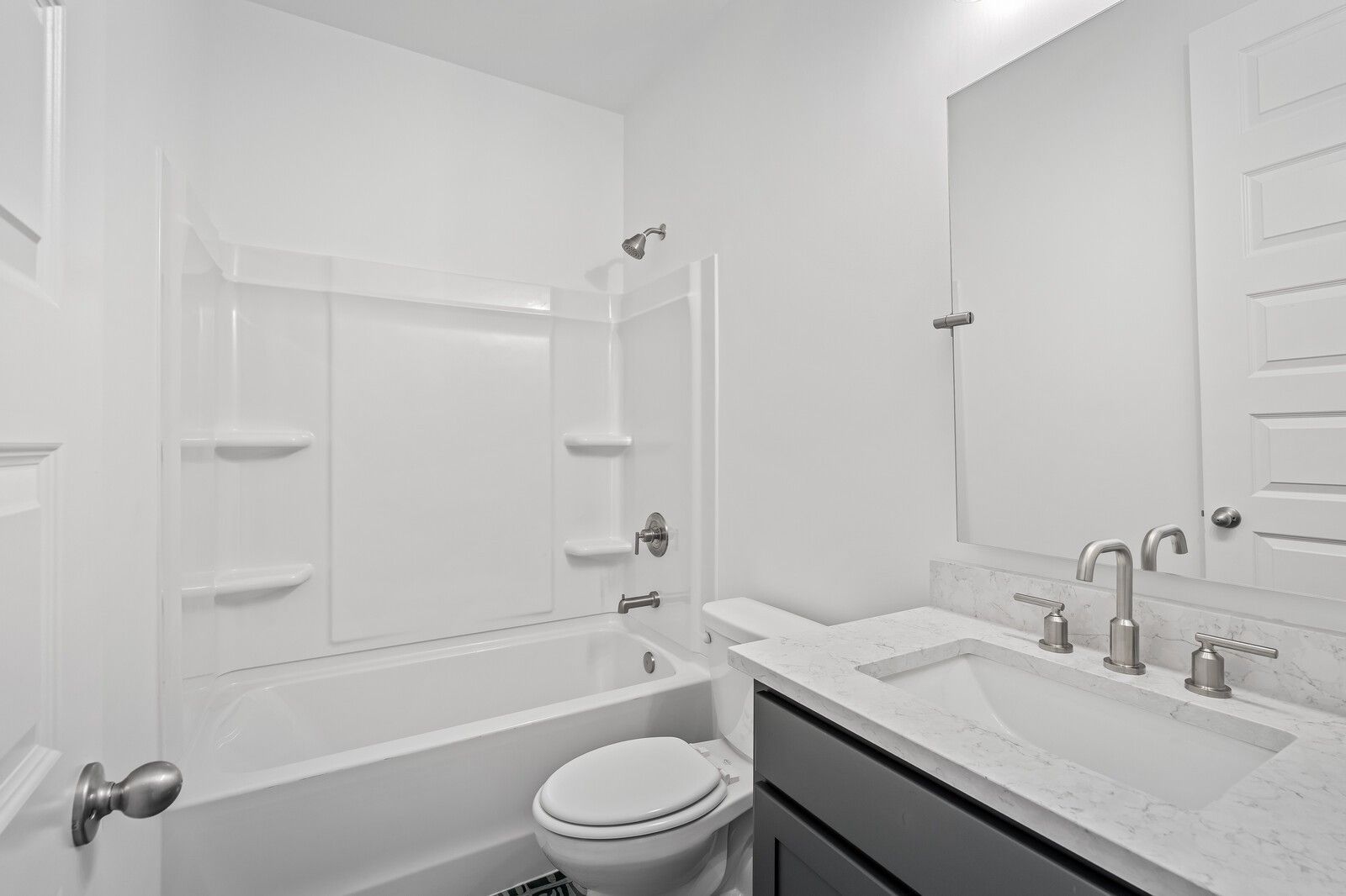 Modern guest bathroom featuring tub-shower combo, quartz vanity sink, white toilet in Davidson Homes The Hawkins, Murfreesboro, TN
