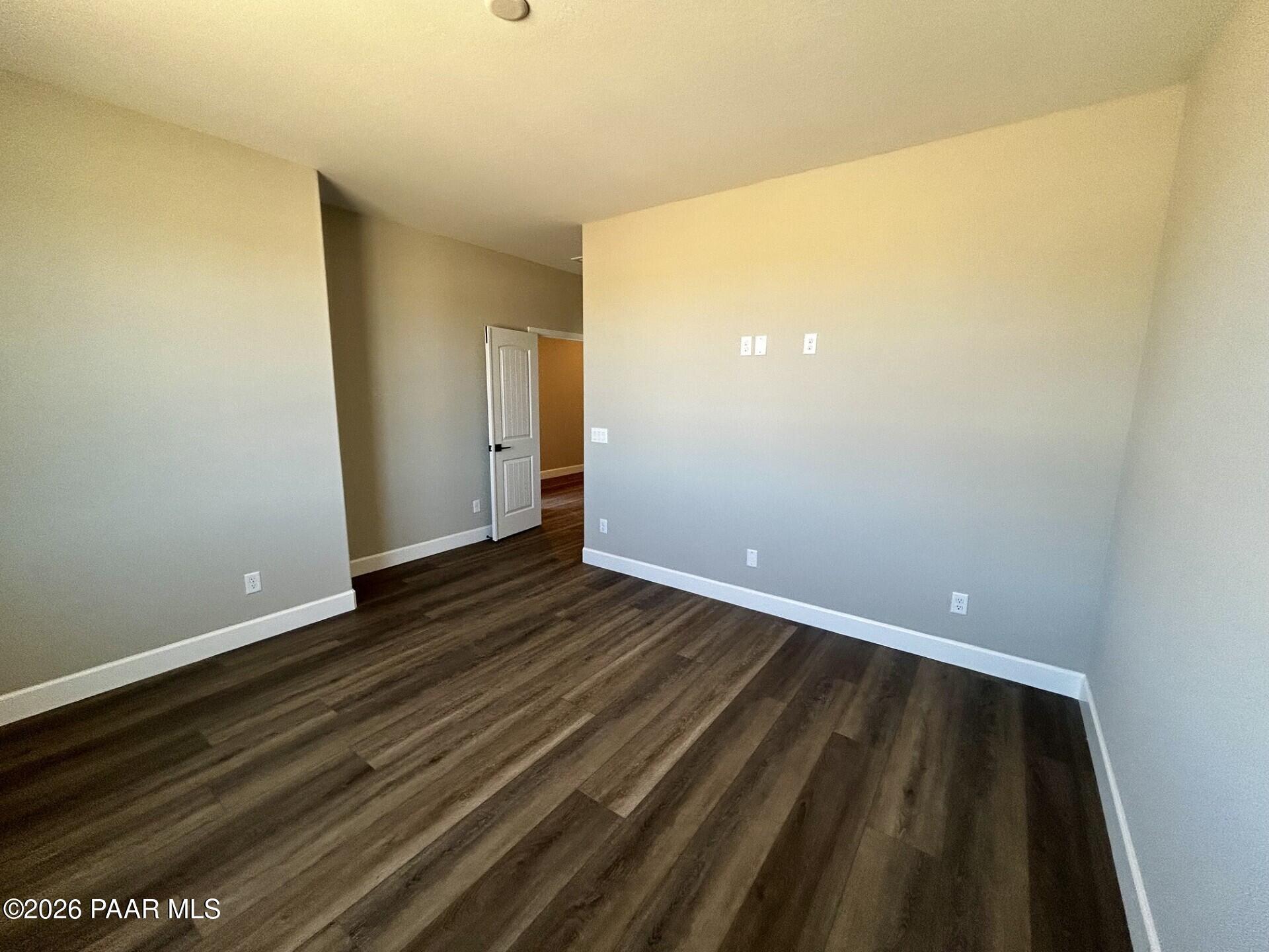 Spacious bedroom with wood-look flooring in The Harmony C floor plan at North Ridge, Pronghorn Ranch, Prescott Valley.